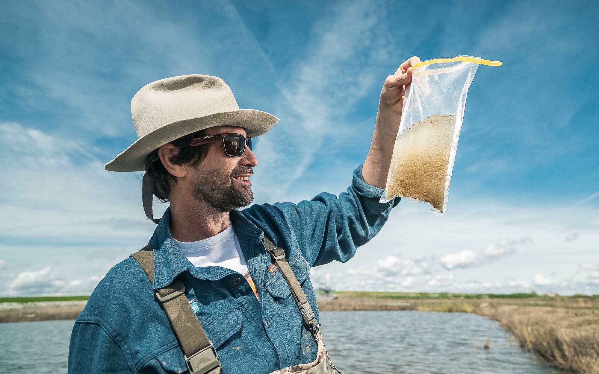 Jacob Katz examines a water sample full of zooplankton, pulled from a flooded rice field at Knaggs Ranch near the Sacramento River.