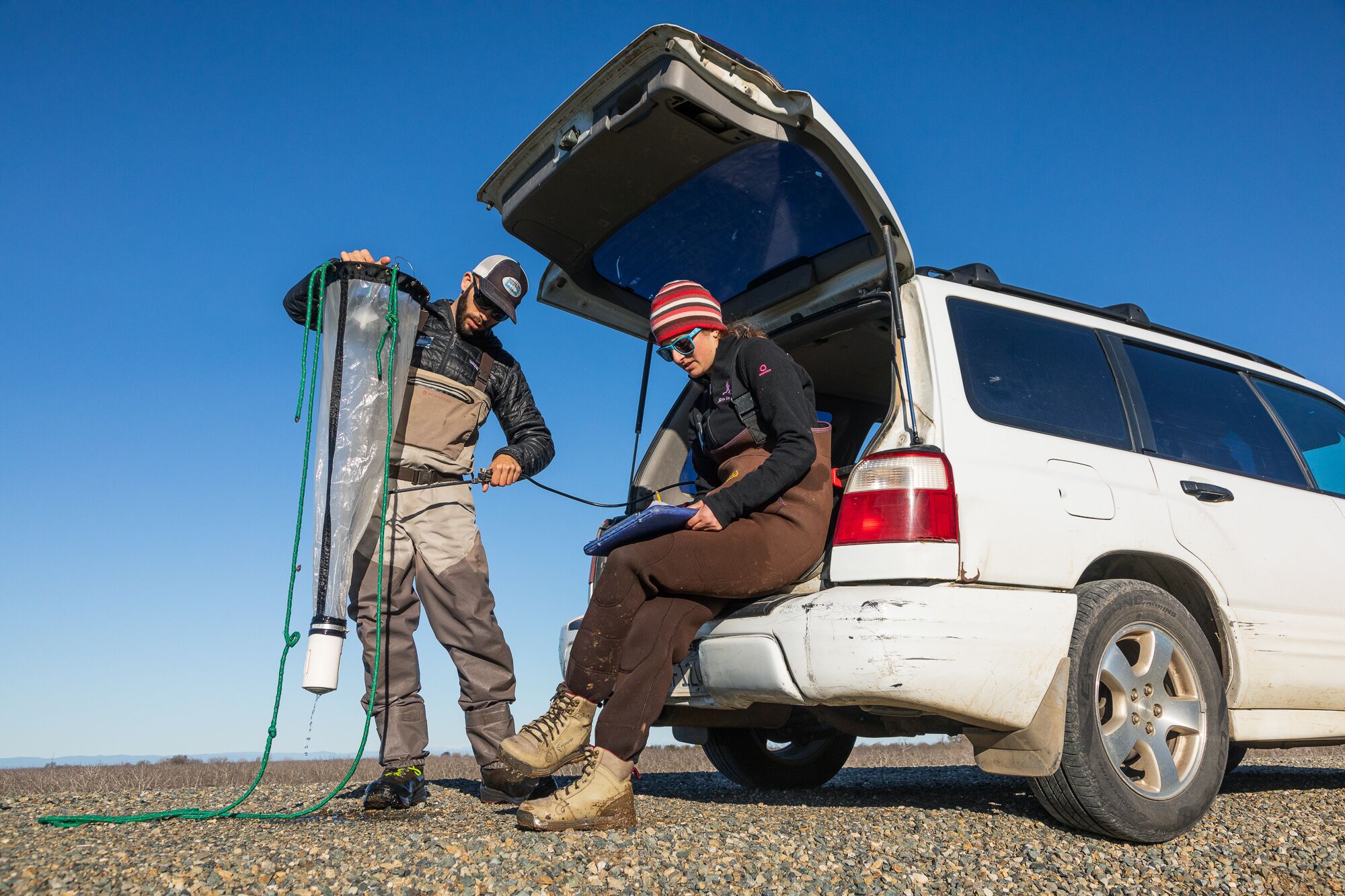 Jacob Montgomery and Jennifer Kronk from California Trout record water sample results in the field.