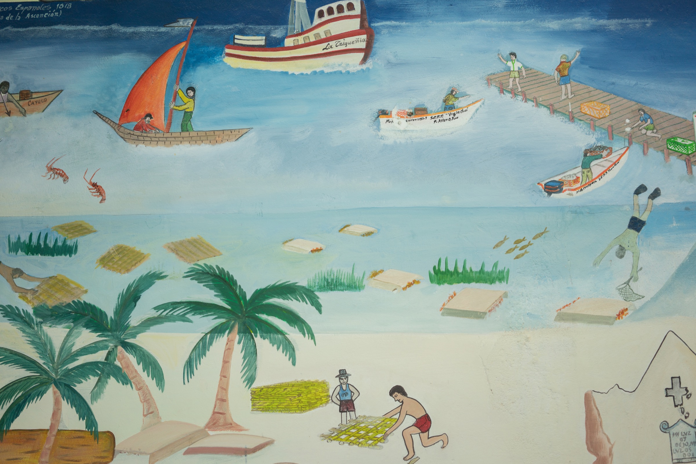 A painting at the offices of La Cooperativa Pesquera de Vigia Chico, a fishing cooperative in Punta Allen, illustrates the importance of lobster fishing to the area and depicts historical versions of lobster traps. Photograph by Dominic Bracco II