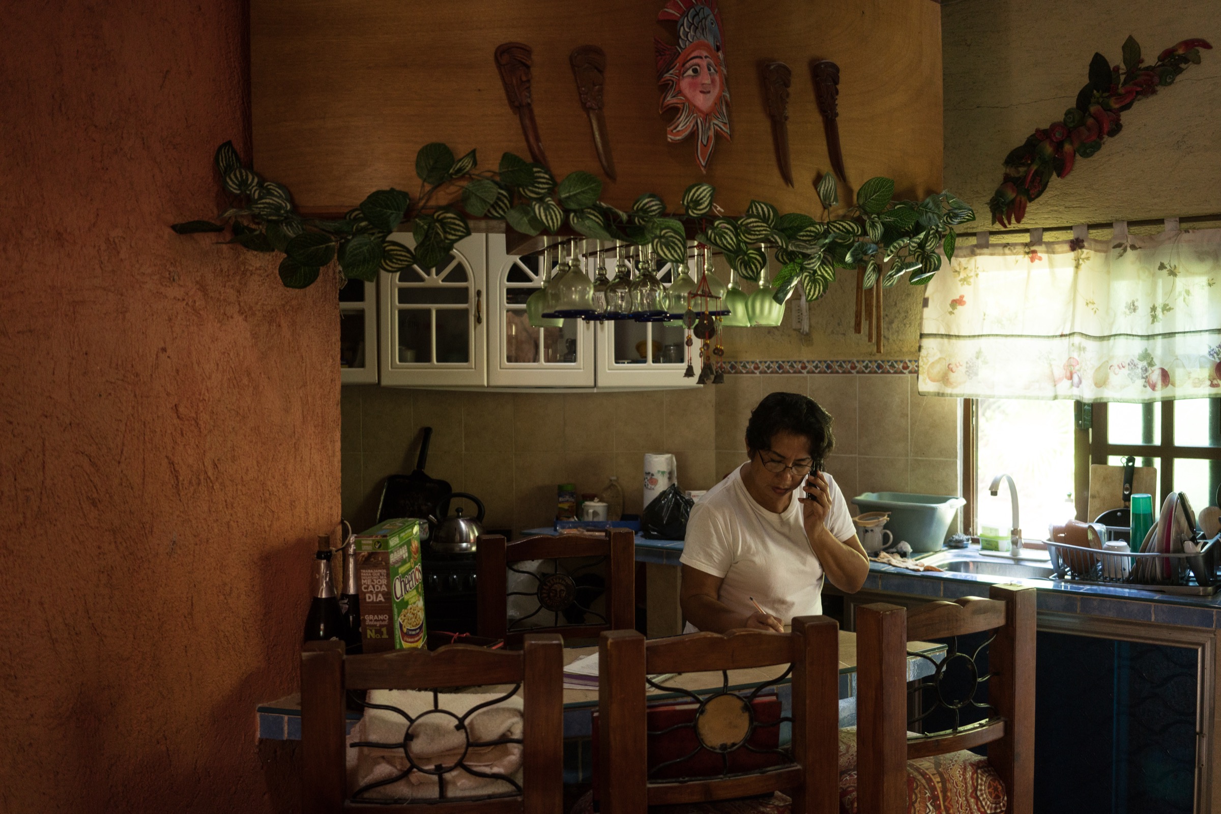 Local historian Mercedes Campos Acosta speaks on the phone with a Mexican anthropologist about the origins of Punta Allen’s lobster fishing techniques. According to Acosta, the idea of using casitas to trap lobsters was first introduced by a military captain from Cuba, who came to Punta Allen to trade with the town’s residents. Photograph by Dominic Bracco II