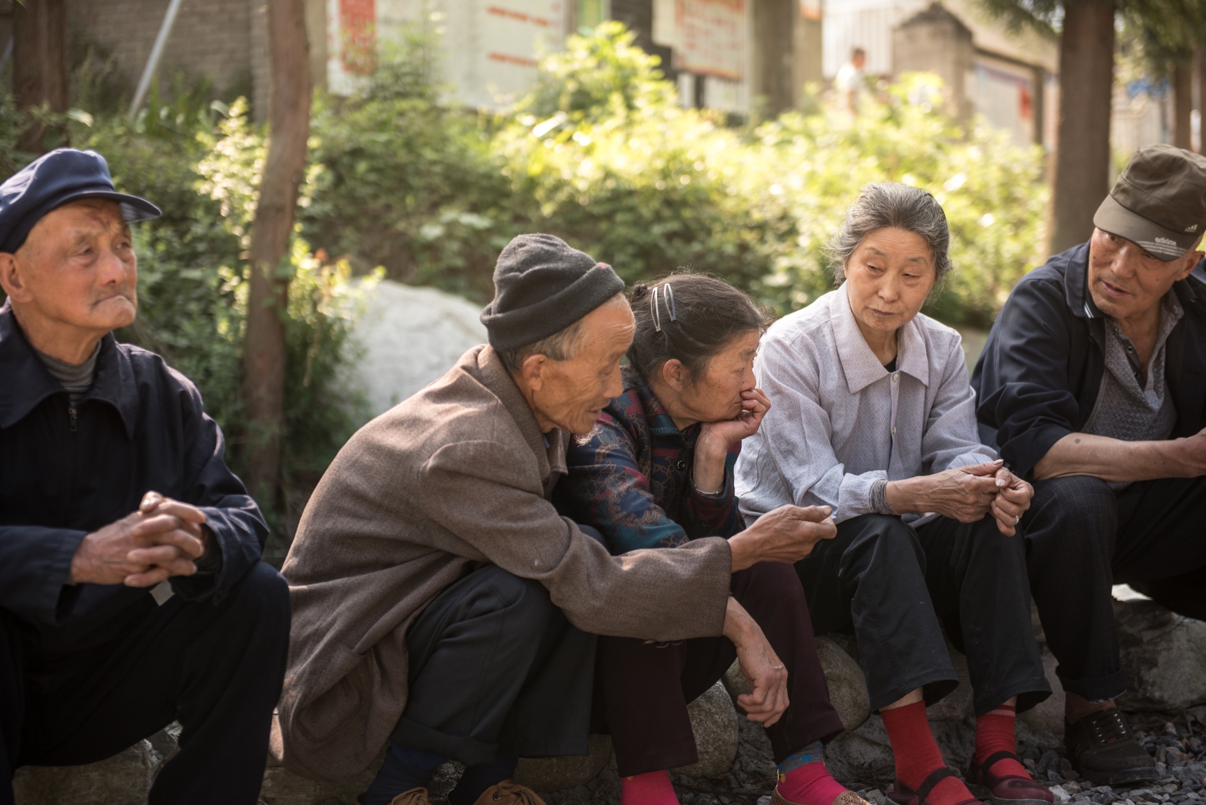 Residents of the community of Guanba gather near the village square. The community is home to just 11 households in the Min Mountains, as younger generations have migrated to the larger cities to find work.Photograph by Kyle Obermann