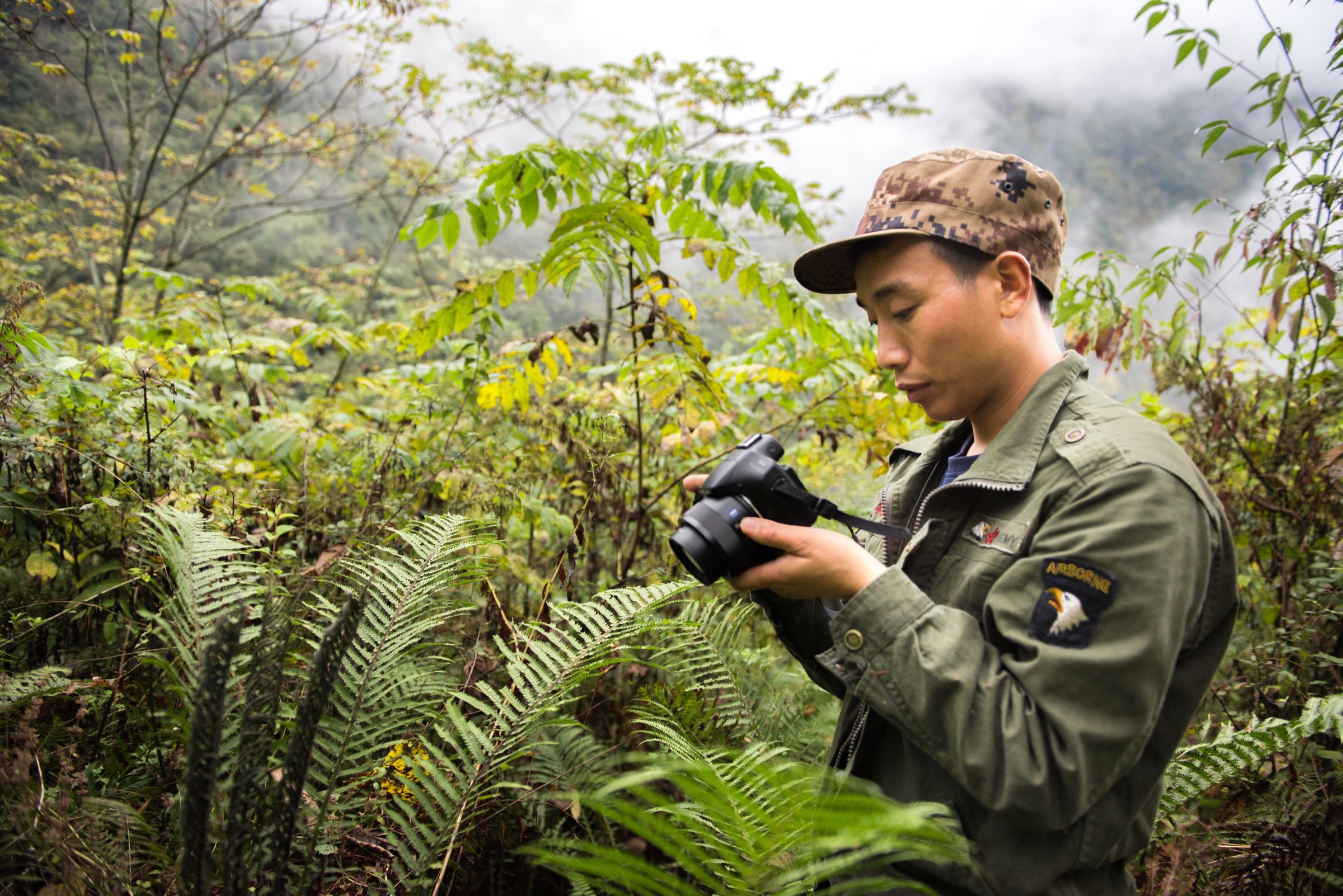 Li Xinrui, a member of Guanba Community Reserve’s patrol team, is in charge of photographing species encountered during the team's patrol of Guanba Valley. Photograph by Kyle Obermann