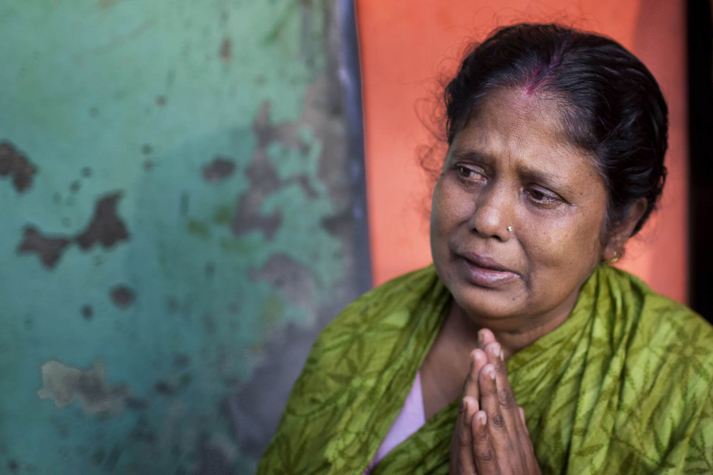 Since 2001, when Nipah virus was first recognized in Bangladesh, the pathogen has taken a heavy toll. This mother in Faridpur prays for her son who fell ill after drinking date palm sap during a gathering to celebrate his graduation from high school. He has since died. Photograph by A.M. Ahad