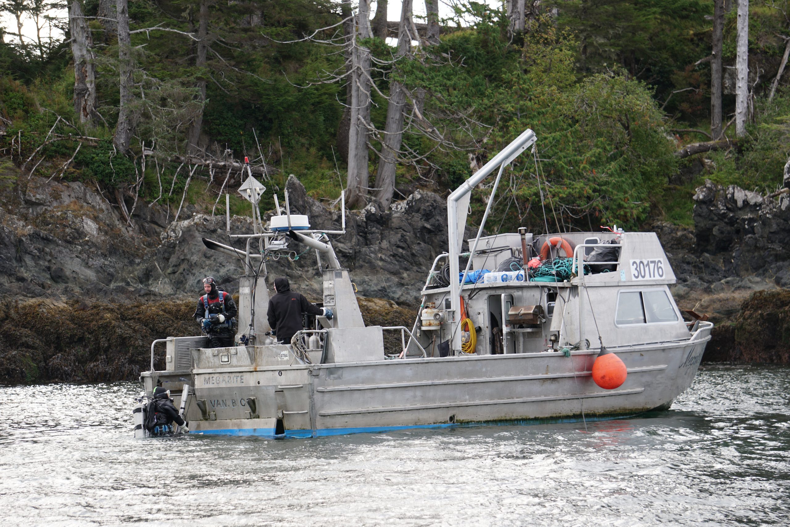Commercial urchin divers wrap up a day working to restore the kelp forest ecosystem off Haida Gwaii by collecting sea urchins and distributing their roe to local communities. Photograph by C. Houston