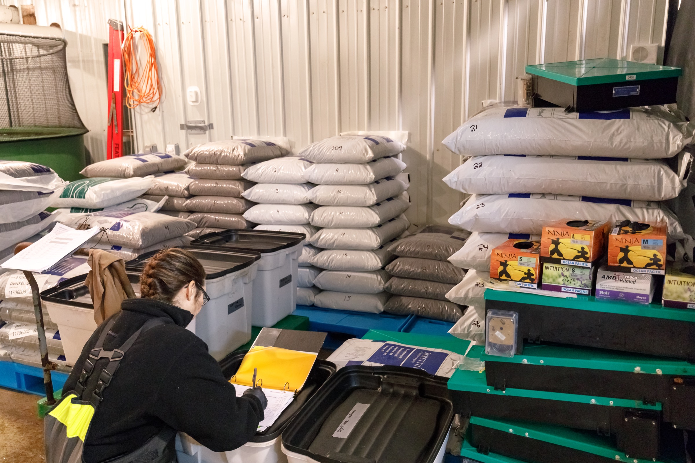 Technician Sheila Peters prepares salmon feed inside the AquaBounty facility. Photograph by Stephen DesRoches