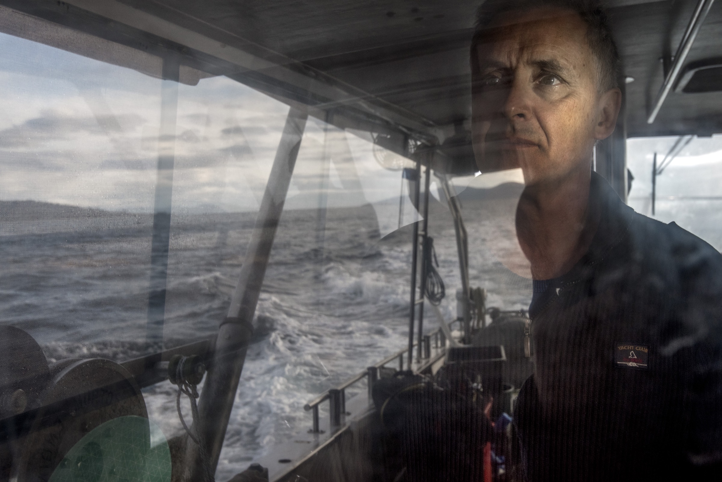 Craig Johnson, a marine ecologist at the University of Tasmania, scans the horizon near one of his study sites off Maria Island, Tasmania.