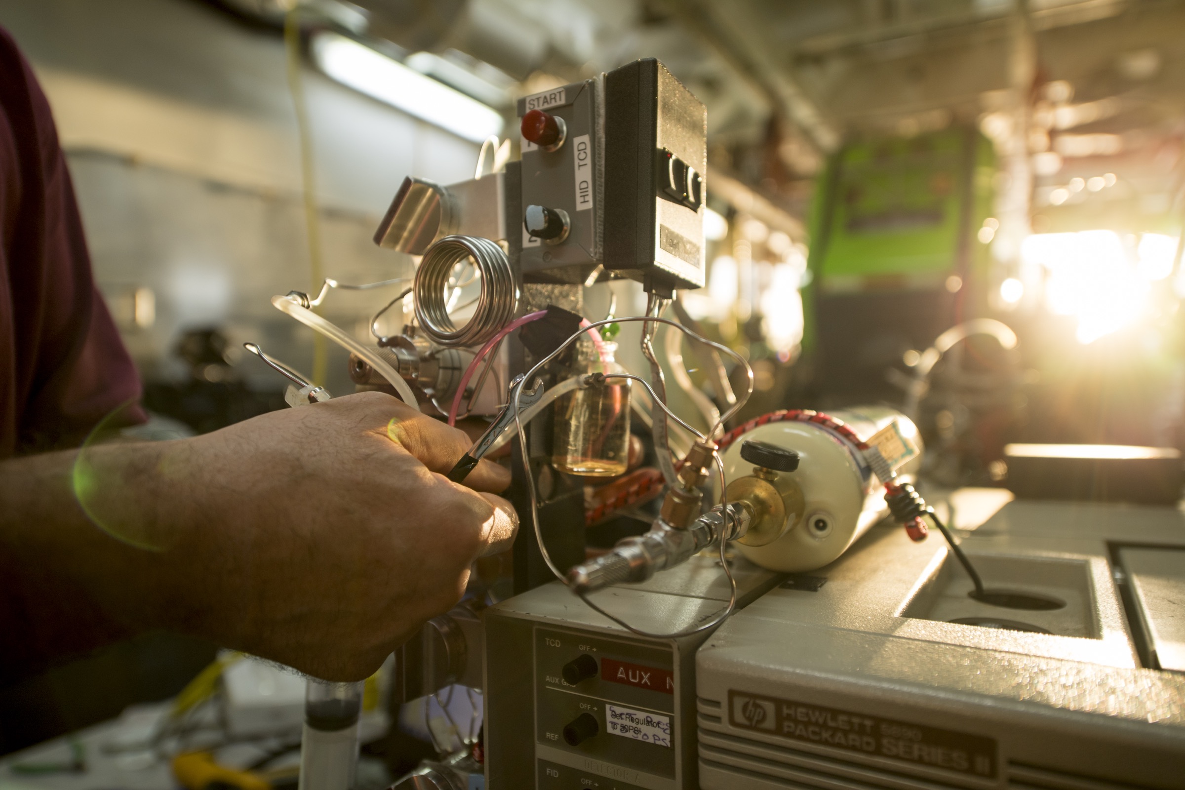 Jeff Seewald, a scientist with the Woods Hole Oceanographic Institution (WHOI), uses a machine he built to measure the chemical make-up of ocean water samples. Photograph by Novus Select