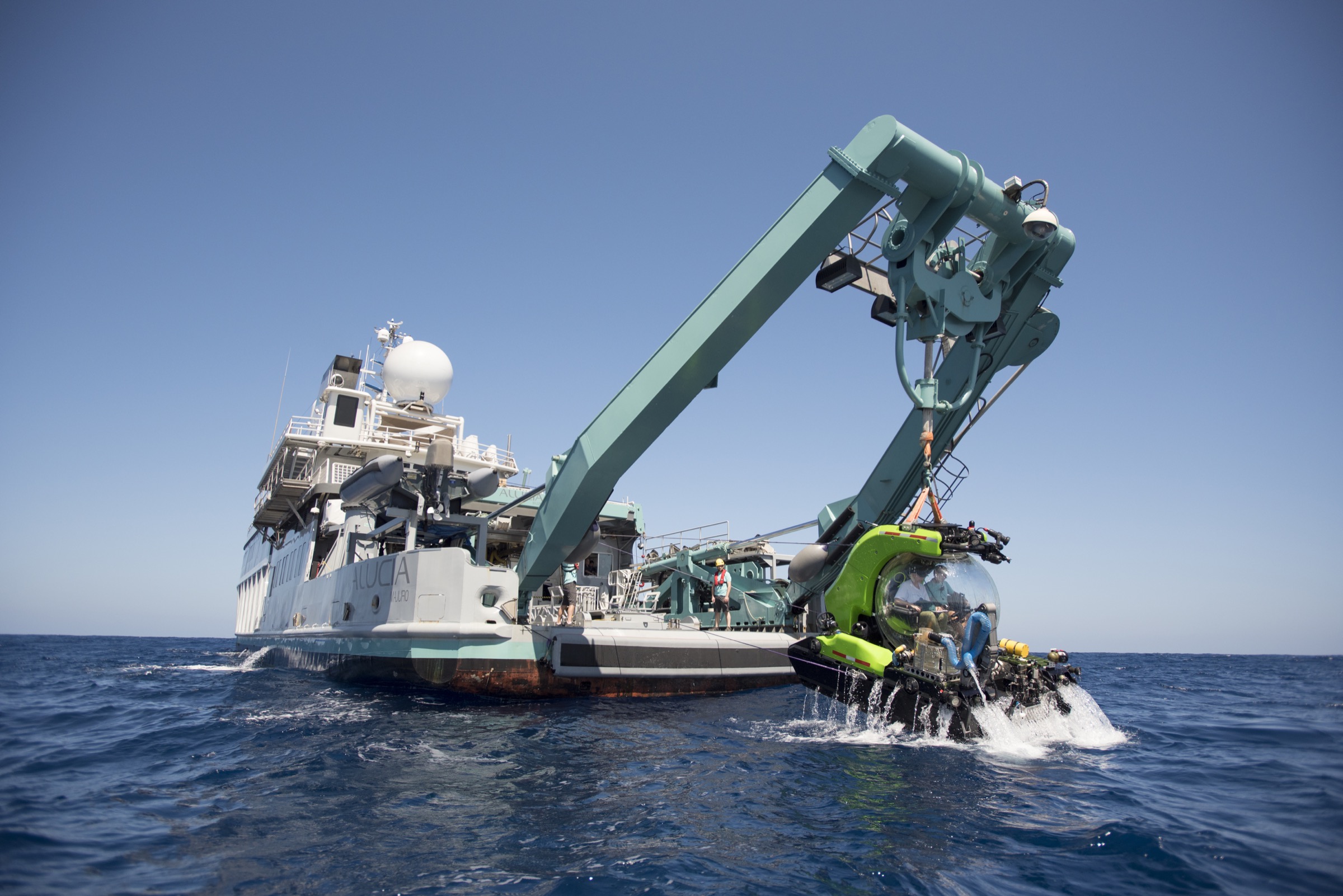 Deep Rover, a specialized scientific deep ocean submersible, is lowered off the side of the M/V Alucia on its way to explore the steep underwater slopes surrounding Saint Peter and Saint Paul Archipelago. Photograph by Novus Select
