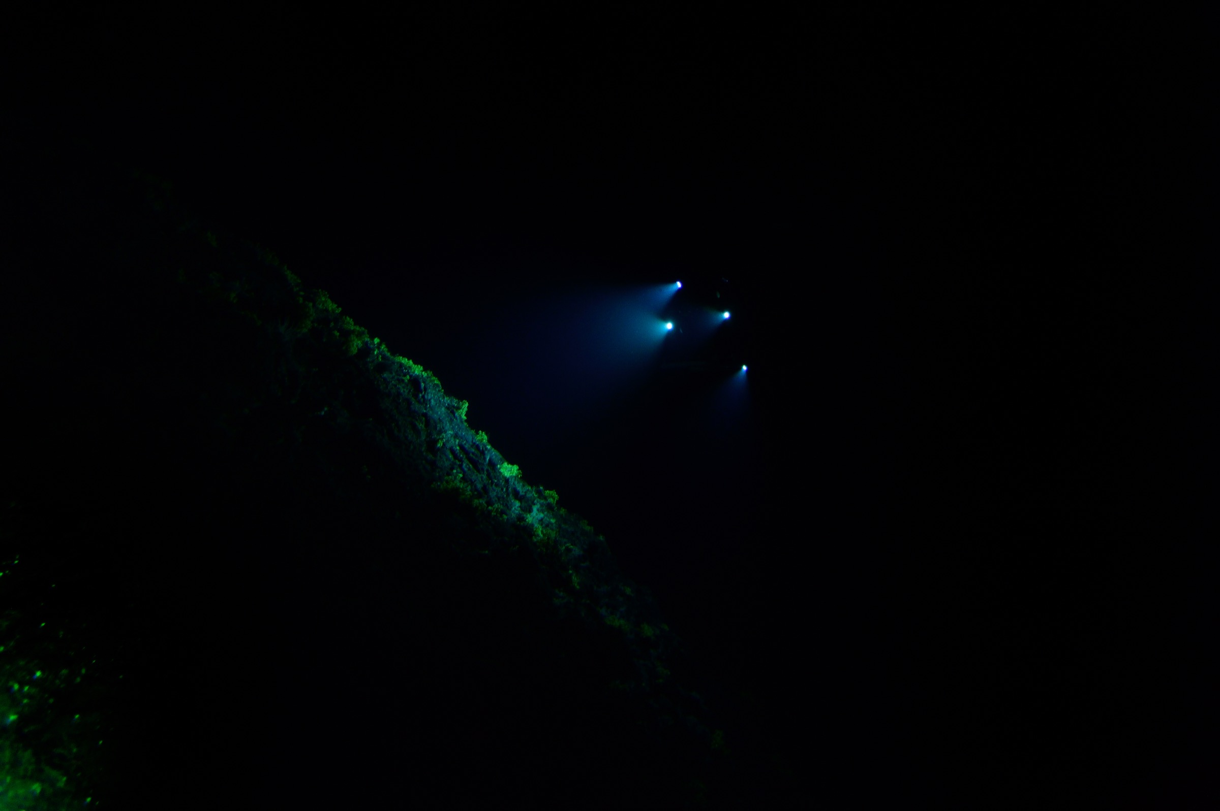 Little is visible below a depth of 500 meters, except the lights of the submersible Deep Rover exploring off the coast of Saint Peter and Saint Paul Archipelago. Photograph by Solvin Zankl