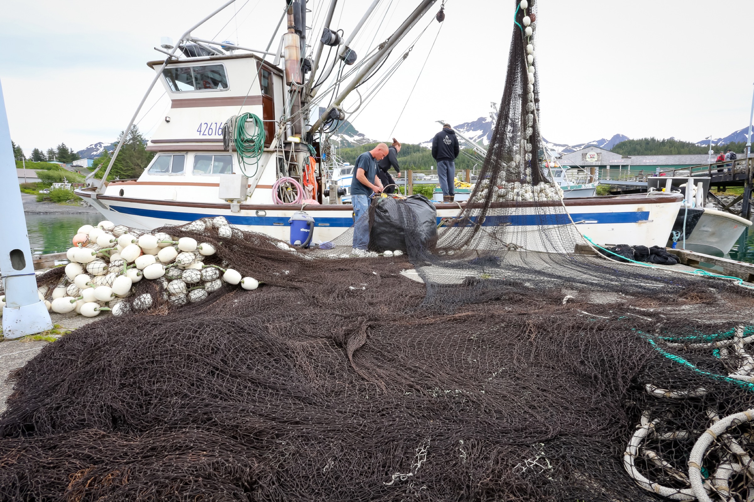 John Renner’s crew mends nets in preparation for an upcoming salmon opener. Photograph by Julia Rosen