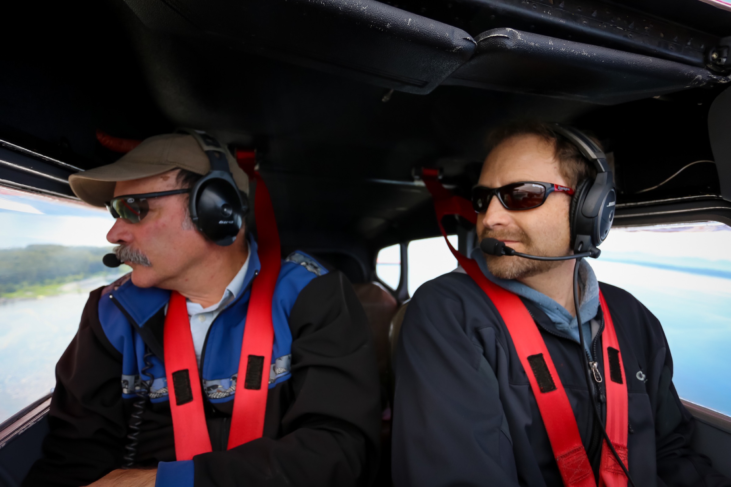 Scott Pegau and pilot Mike Collins search for herring above Prince William Sound. Photograph by Julia Rosen