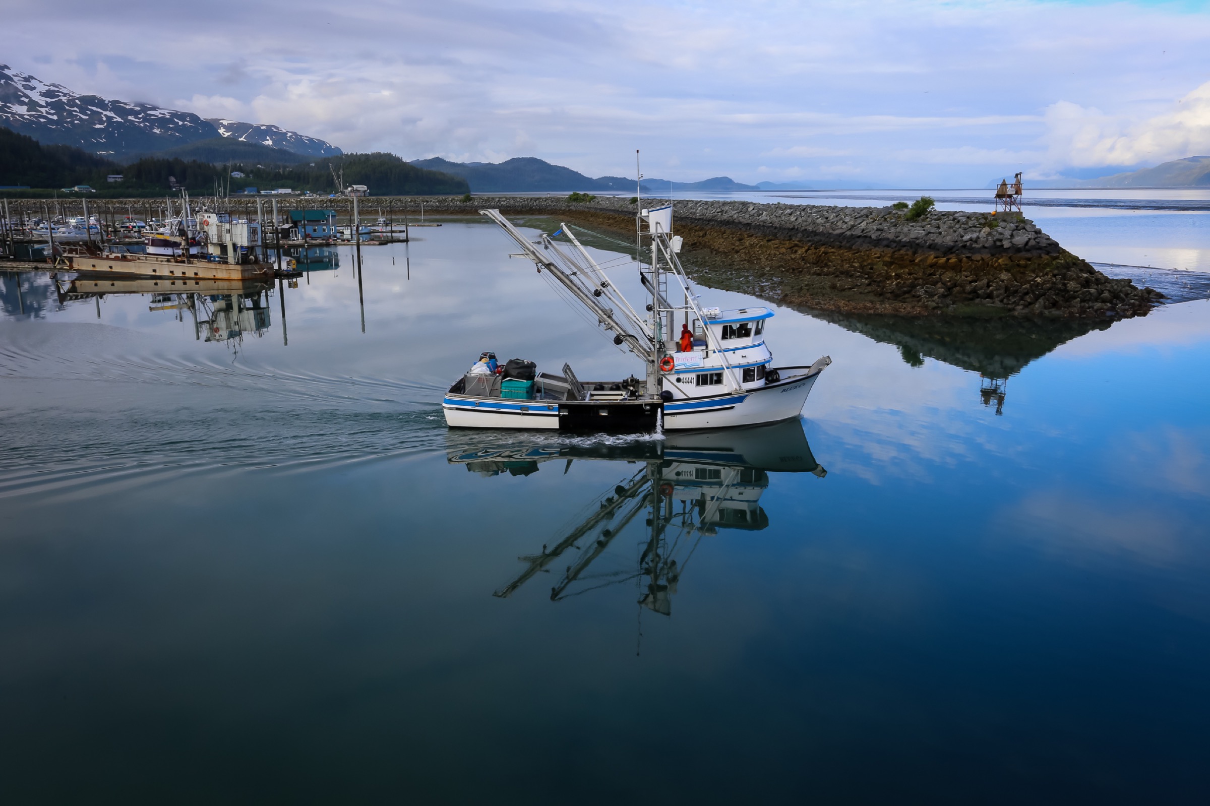 A non-operational fishing boat heads out of Cordova harbor. Photograph by Julia Rosen