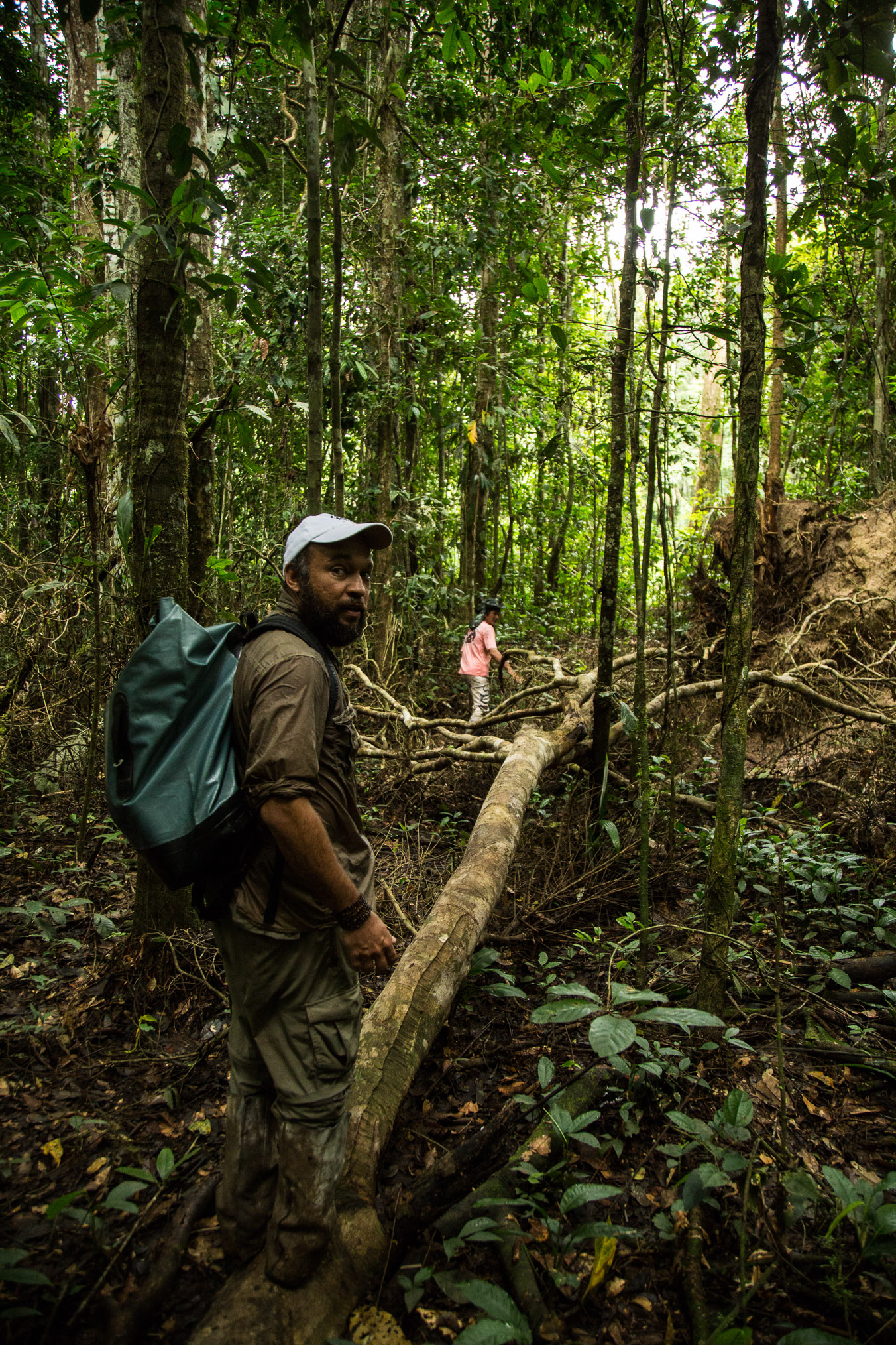 Brazilian primatologist Felipe Ennes follows a local guide down an overgrown trail to search for saki monkeys in the Amazon rainforest.