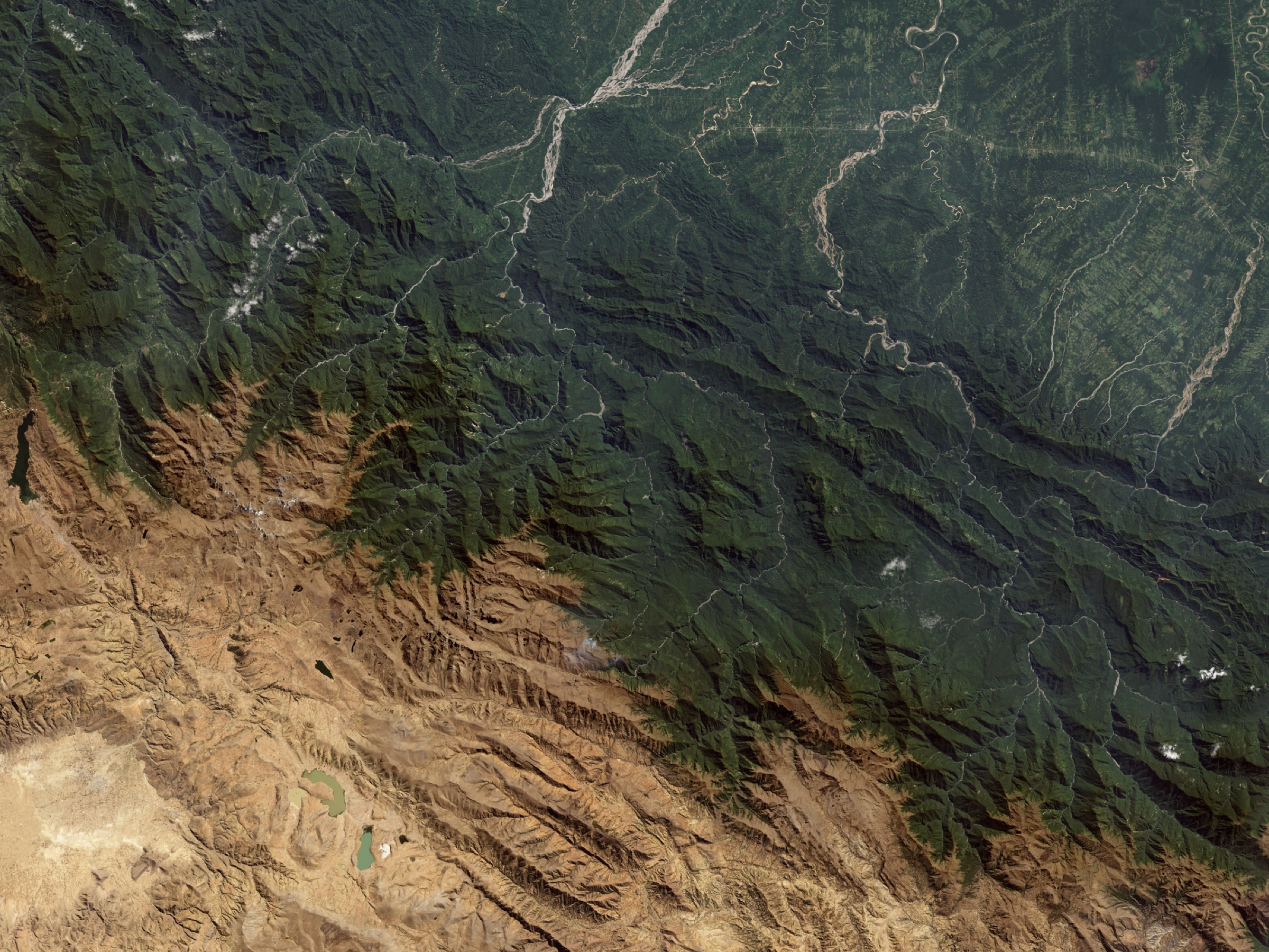 A satellite image of the Andes Mountains showing a wide range of habitats, including those fragmented by agriculture in the upper-right portion of the photo—Photograph by Stocktrek Images/Getty