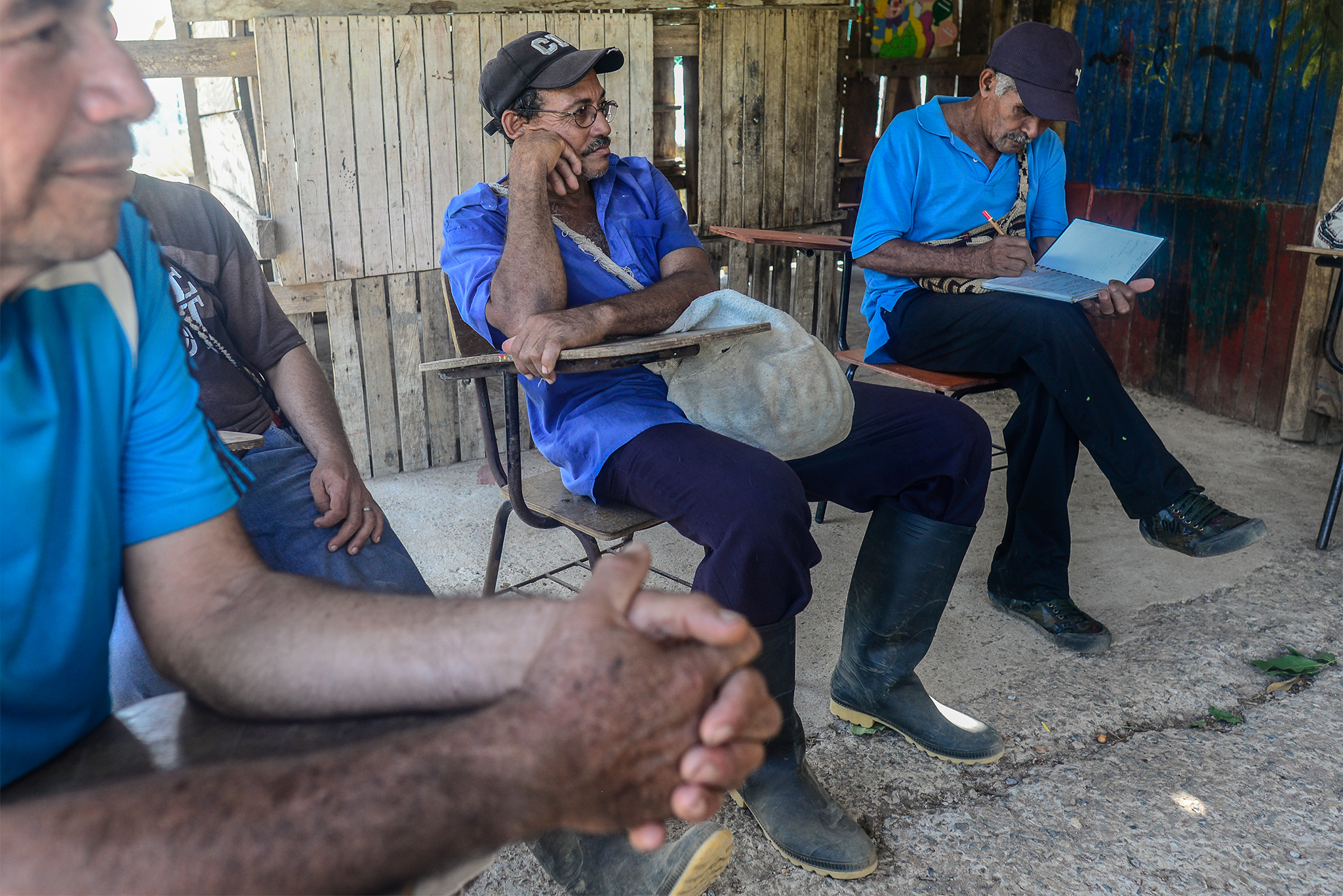 Wilfredo Acósta sits in the Santa Rita schoolhouse after hiking guide training near his home. Photograph by Lindsay Fendt