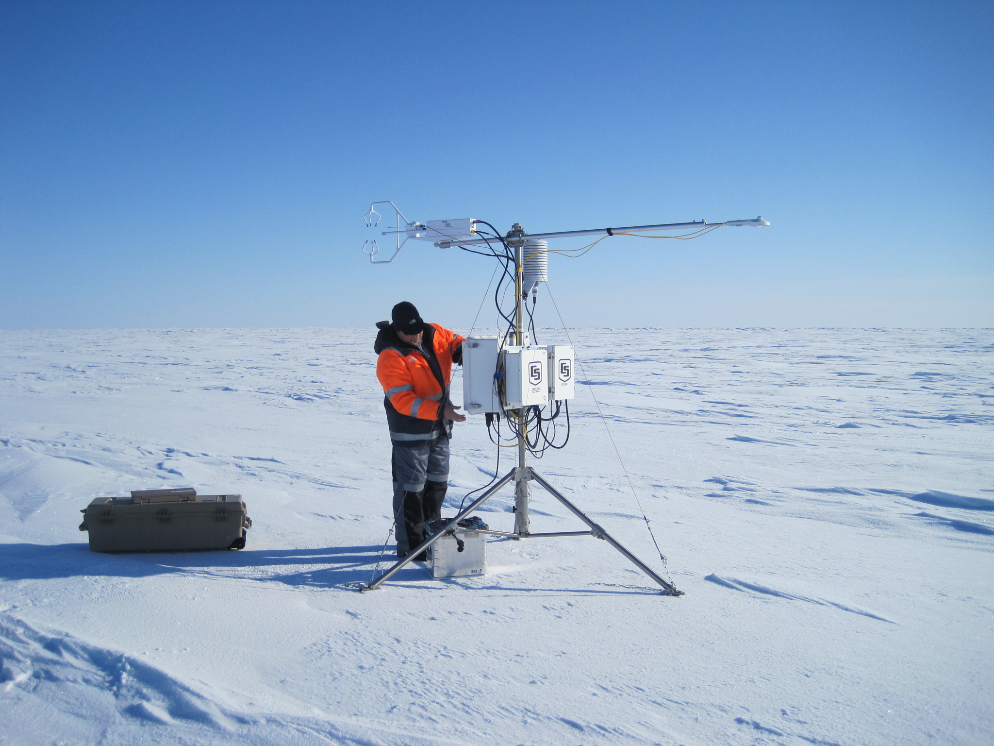 A researcher makes final adjustments to an instrument that takes measurements of wind and temperature 20 times per second—helping scientists understand the atmosphere’s effects on sea ice. Photograph by Mats Granskog/Stephen Hudson, Norwegian Polar Institute