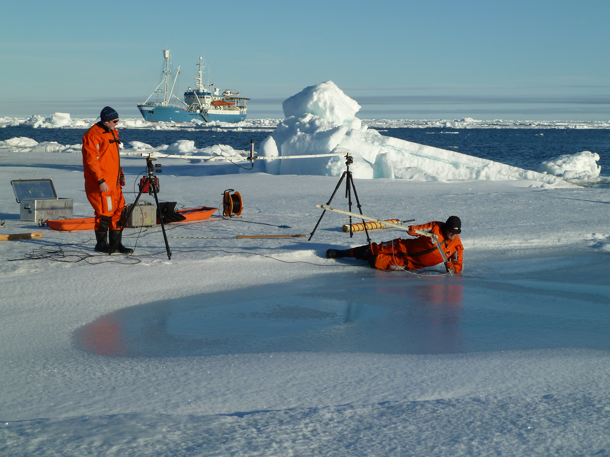 Researchers study melting ponds of various sizes and depths across the surface of the ice to better understand how the makeup of the surface affects reflection and absorption. Open water tends to absorb significantly more of the sun’s energy, and ultimately accelerates the melting of surrounding sea ice. Photograph by Sebastian Gerland, Norwegian Polar Institute