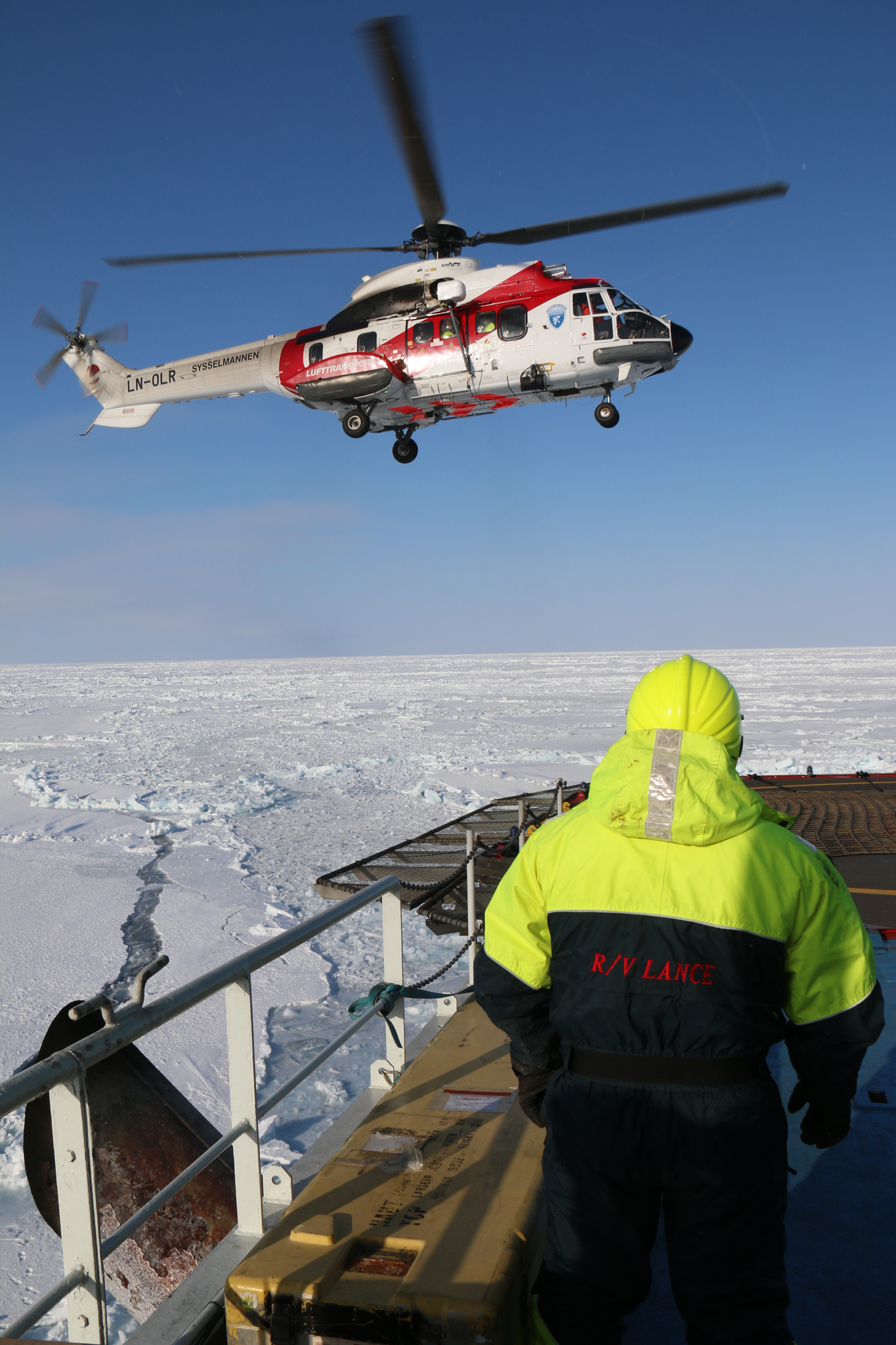 A helicopter transports expedition scientists from the ship to more remote field sites. Photograph by Mats Granskog, Norwegian Polar Institute