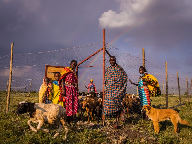 Members of Pilot’s family stand at the gate of his new boma.