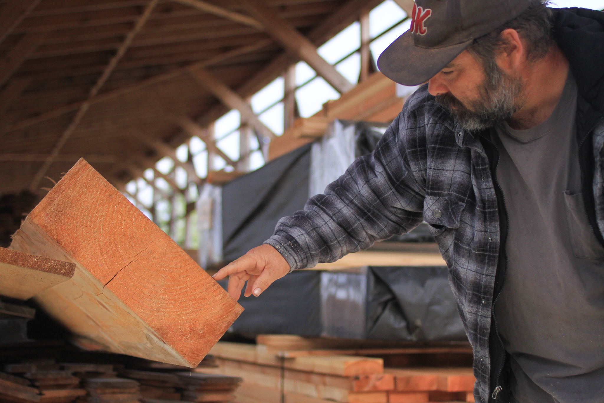 Josh Kohn shows off a beam made out of young growth.