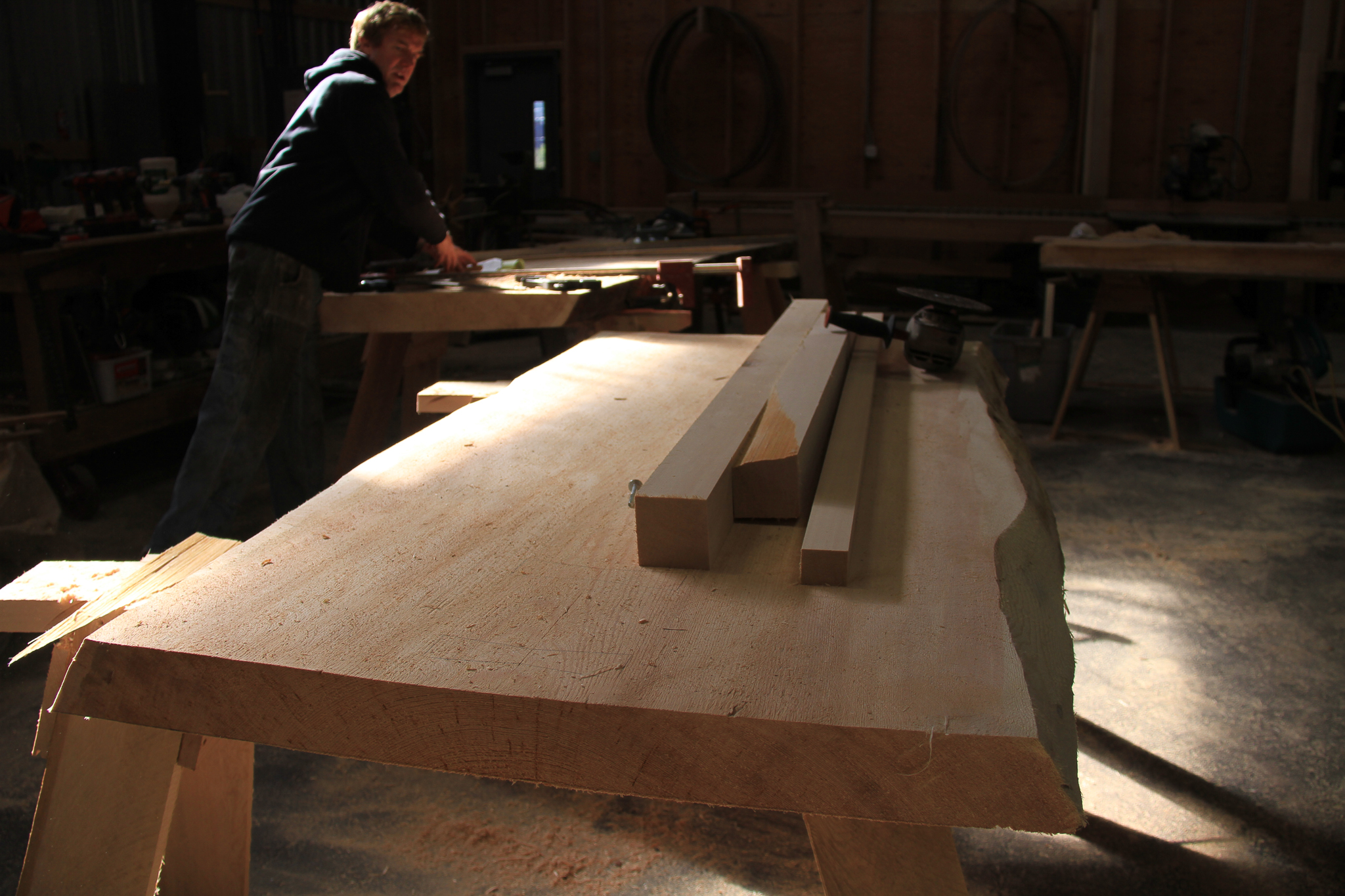 Like many of the small mills in Southeast Alaska, Larry Jackson’s Tongass Forest Enterprises in Ketchikan makes value-added products out of old-growth trees. Here, Jackson shows some slab tables that will fill a custom order from a local family.
