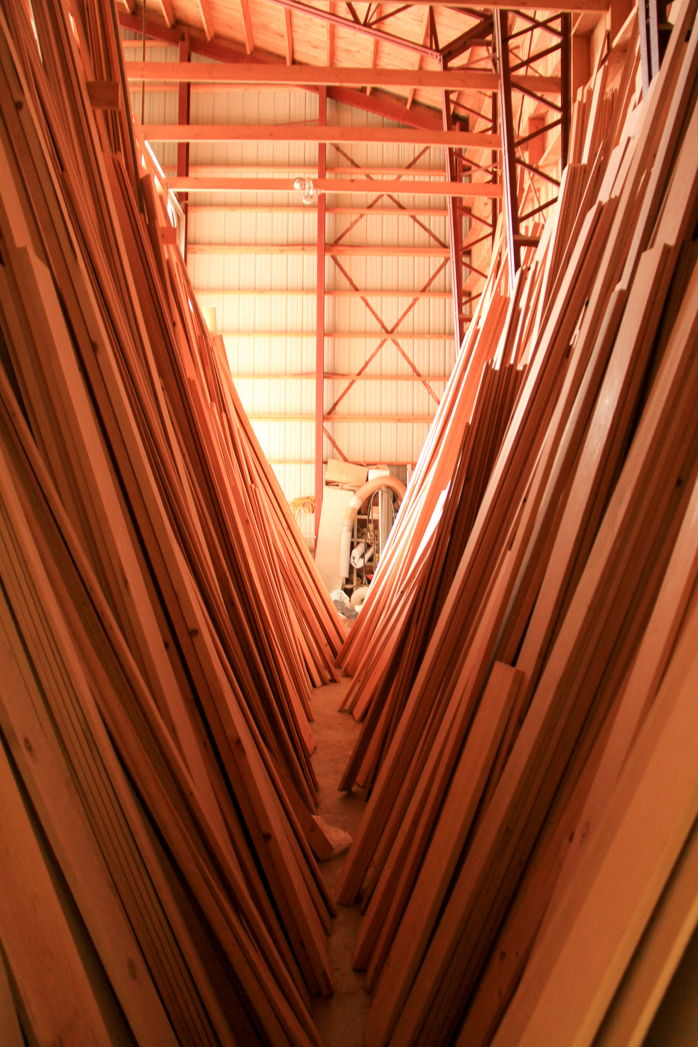 Stacks of clear boards sawn from old-growth trees line the walls of a warehouse at Icy Straits Lumber, near Hoonah, Alaska.