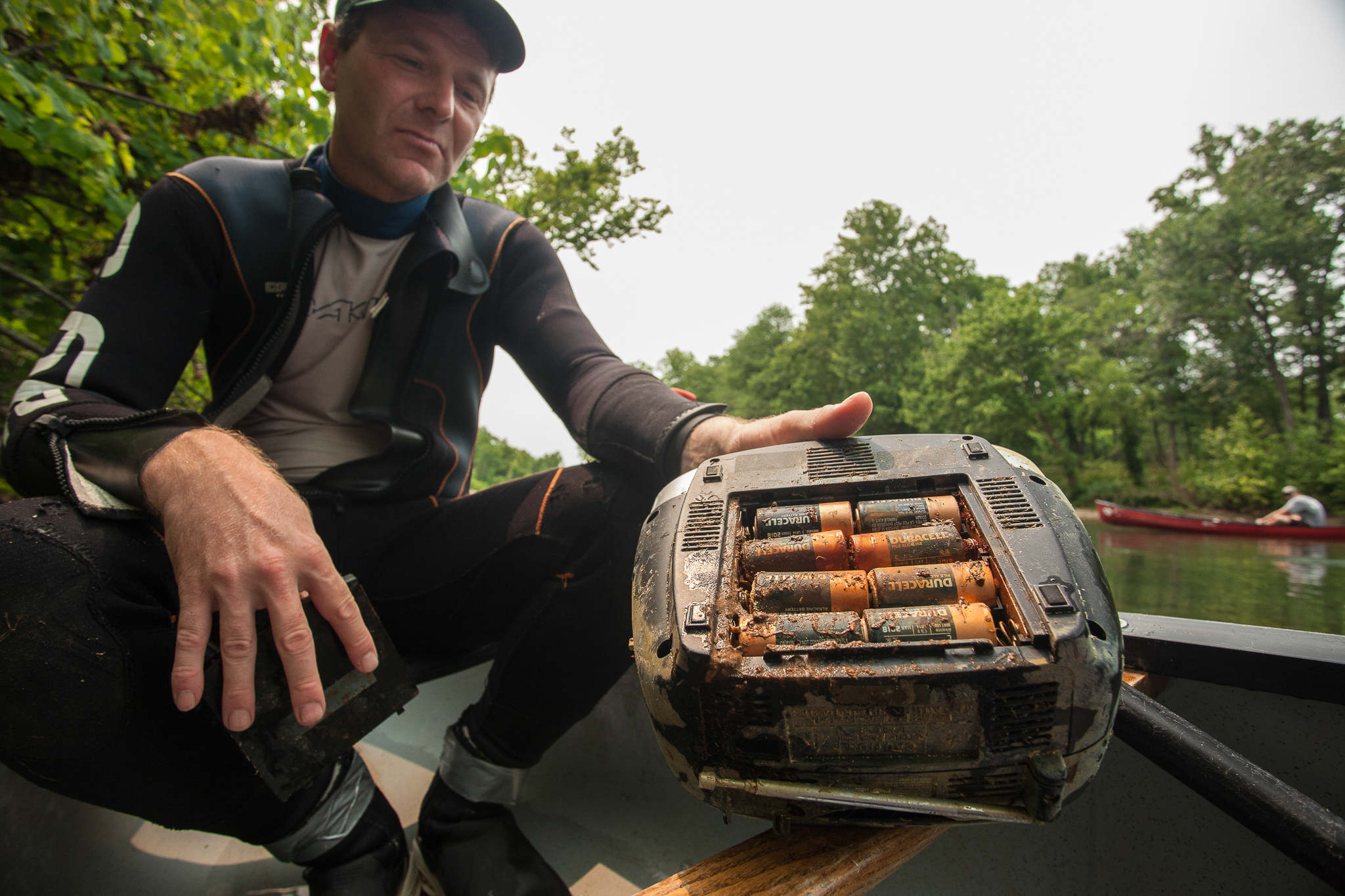 Water pollution is one of the many threats to Ozark hellbenders. Herpetologist Jeff Briggler with the Missouri Department of Conservation holds up one of the culprits—a discarded radio filled with corroded, leaking batteries.