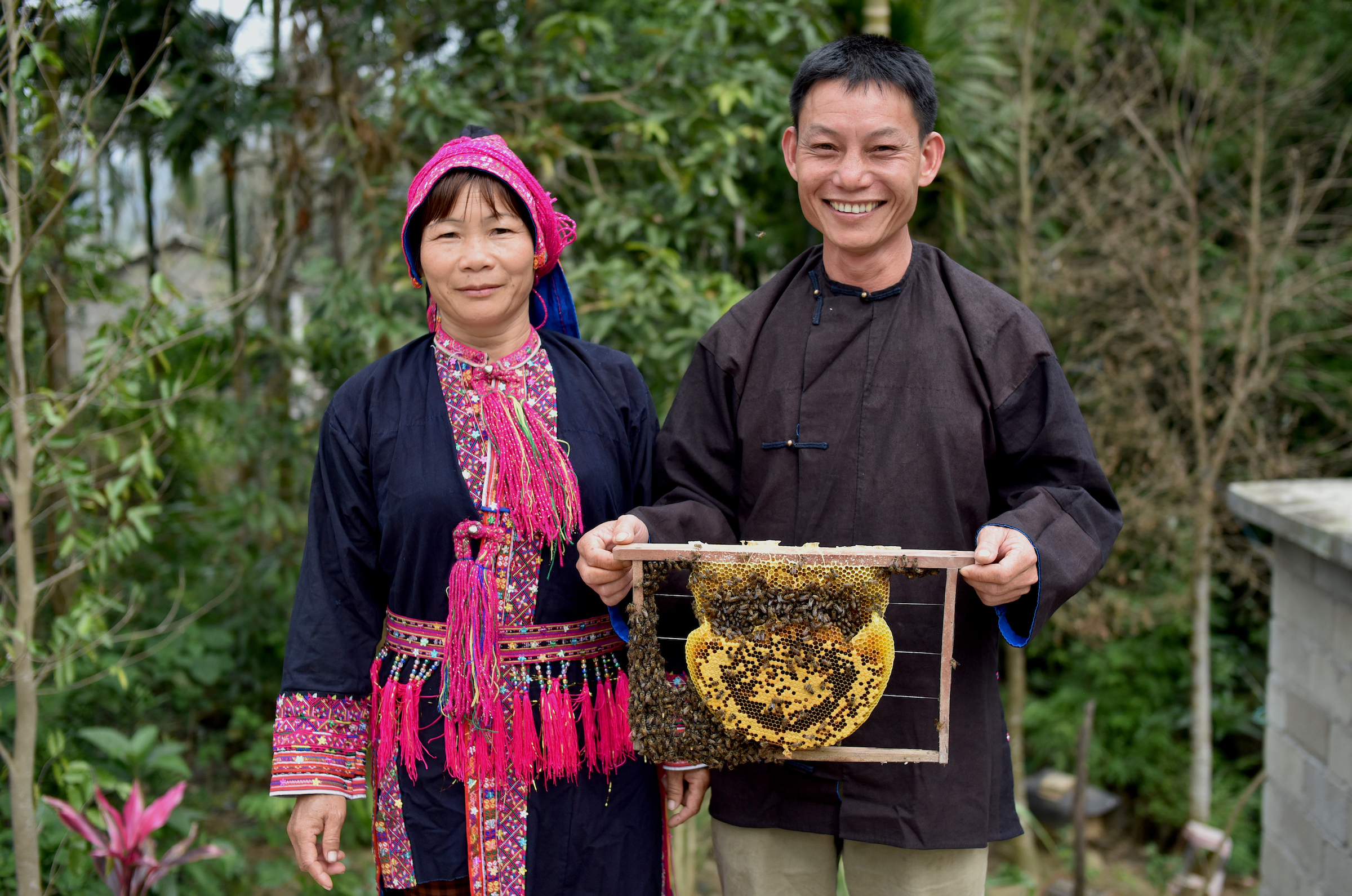 Li Wenyong and his wife Xiumei hold up a honeycomb from one of their hives. Conservationists hope that honey may provide a sustainable source of income for people in Hainan. Photograph courtesy of Kadoorie Farm & Botanic Garden