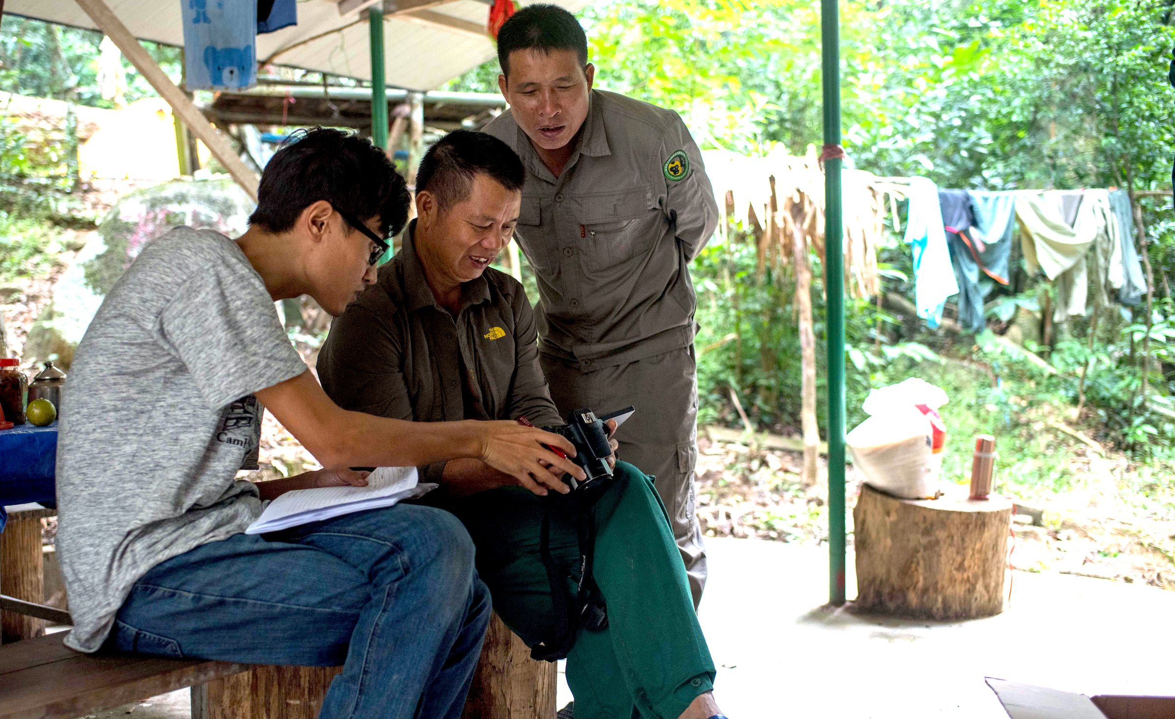 Members of the Hainan gibbon monitoring team review photos of gibbons taken in the Bawangling National Nature Reserve in Changjiang, South China's Hainan Province. Photograph by Xinhua News Agency