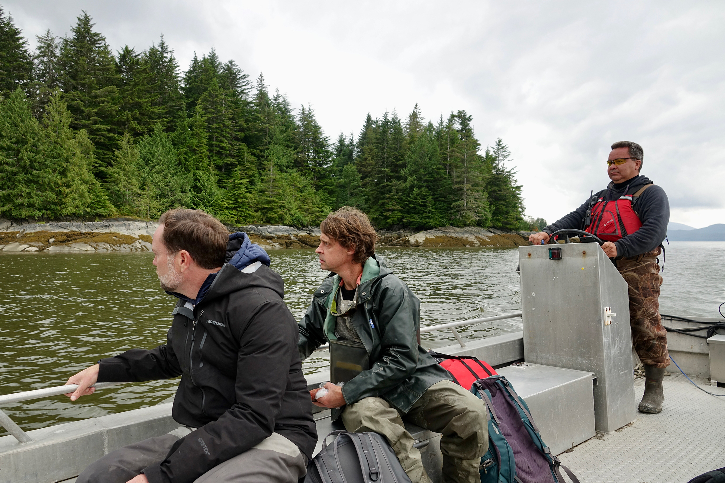 From left to right, SkeenaWild’s executive director, Greg Knox, science director, Michael Price, and Indigenous engagement specialist, Hup-Wil-Lax-A (Kirby Muldoe) look out at what remains of the once-bustling cannery town of Port Essington near the mouth of the Skeena River. Photograph by Lesley Evans Ogden