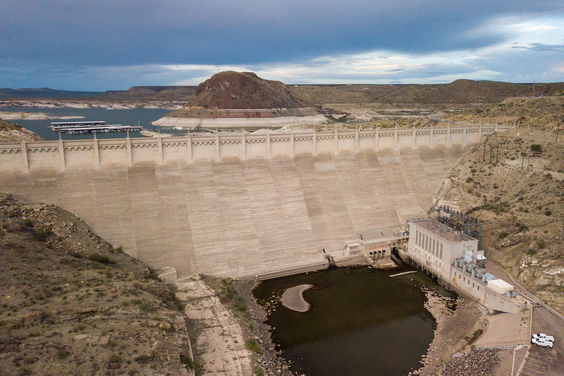 The Elephant Butte Reservoir created by damming the Rio Grande. The horizontal white lines on the butte are formed as water evaporates and leaves behind salts, indicating historic water levels. As of August 2021, the reservoir was just 5% full.