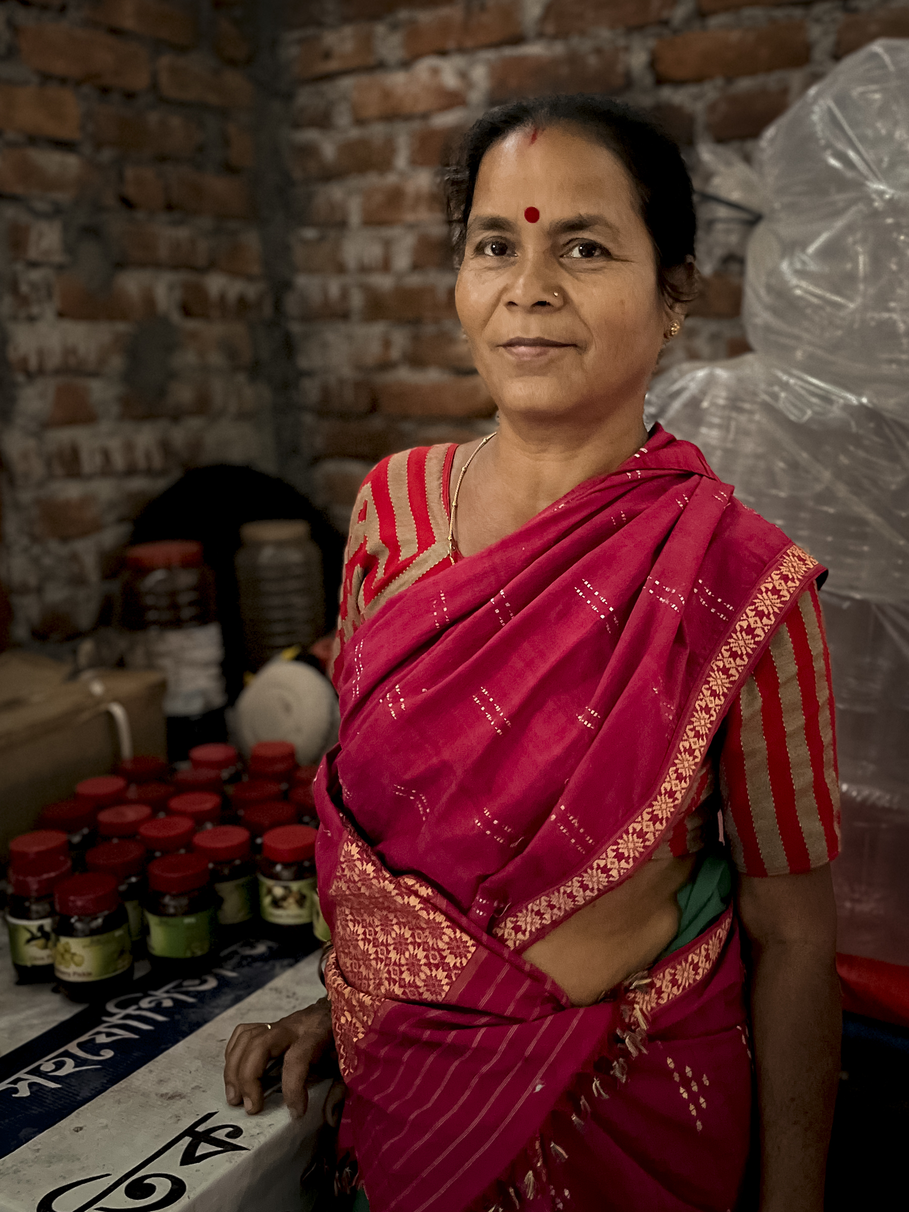 Dharitri Pathak, a member of a group of families of ex-poachers in Barengabari, Manas National Park, Assam, poses with jars of pickles she has made. Photograph by Geetanjali Krishna