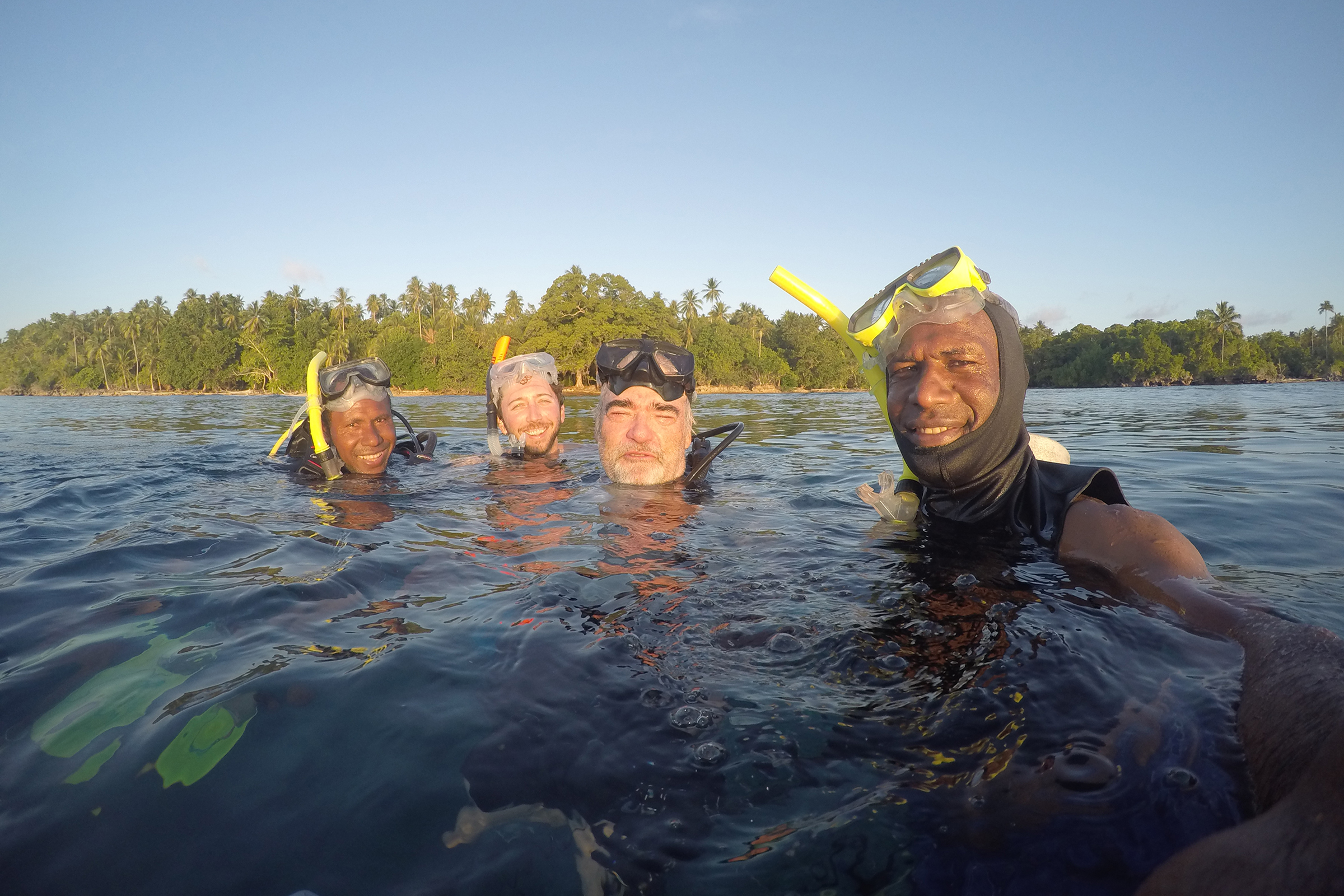 Researchers (from right) Manuai Matawai, Peter Ward, Gregory Barord, and Pomat Kanawi snorkel in search of nautiluses off Ndrova Island. Photograph by Manuai Matawai