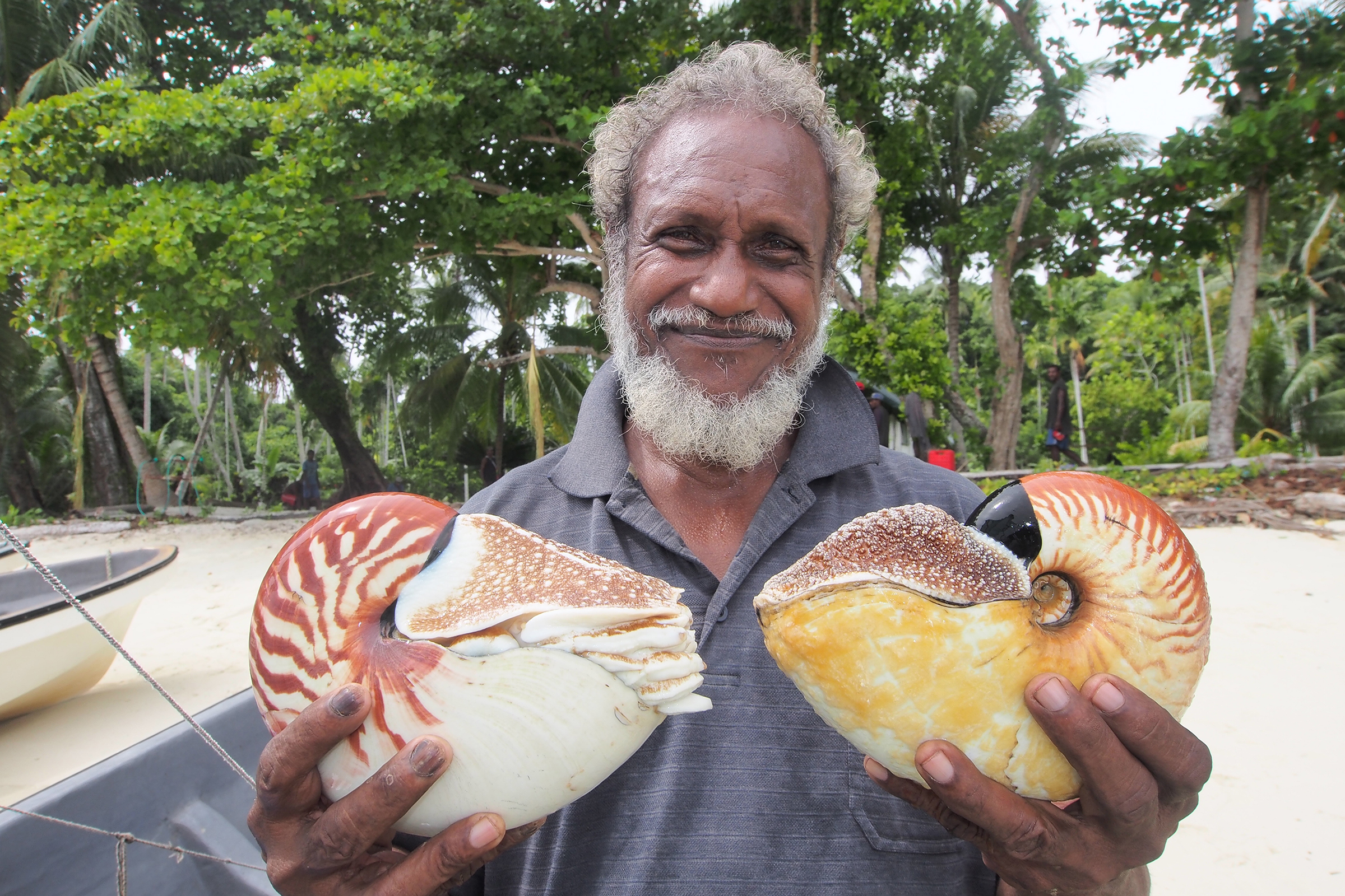 Ndrova Island Chief Peter Kanawi holds two species of nautilus found off his island’s coast. Photograph by Peter Ward