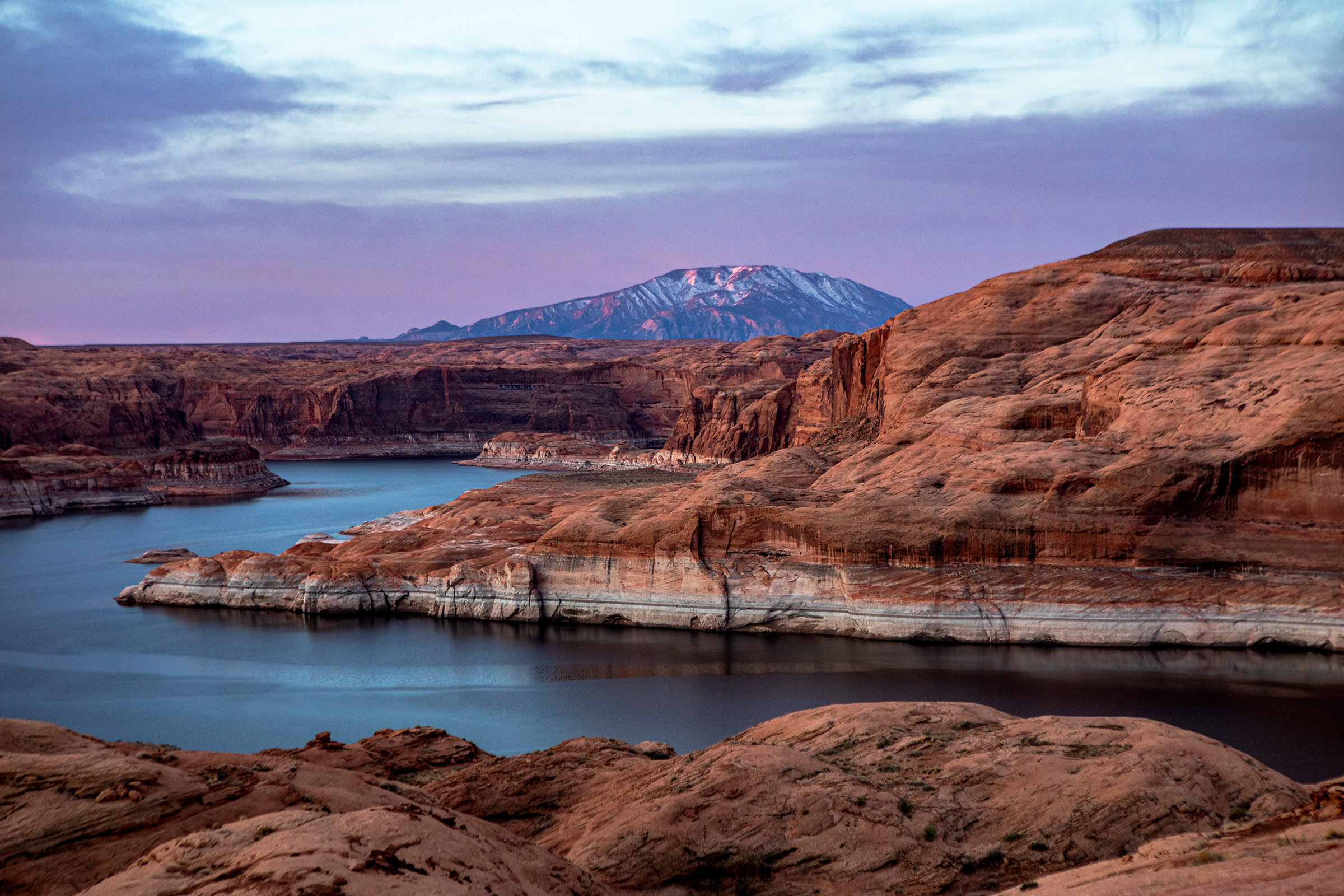 Looking downstream near Glen Canyon’s Gretchen Bar, where relics of once-busy gold mining operations lie beneath Lake Powell. The white mineralization or “bathtub ring” along the main channel indicates the reservoir’s former high-water mark.