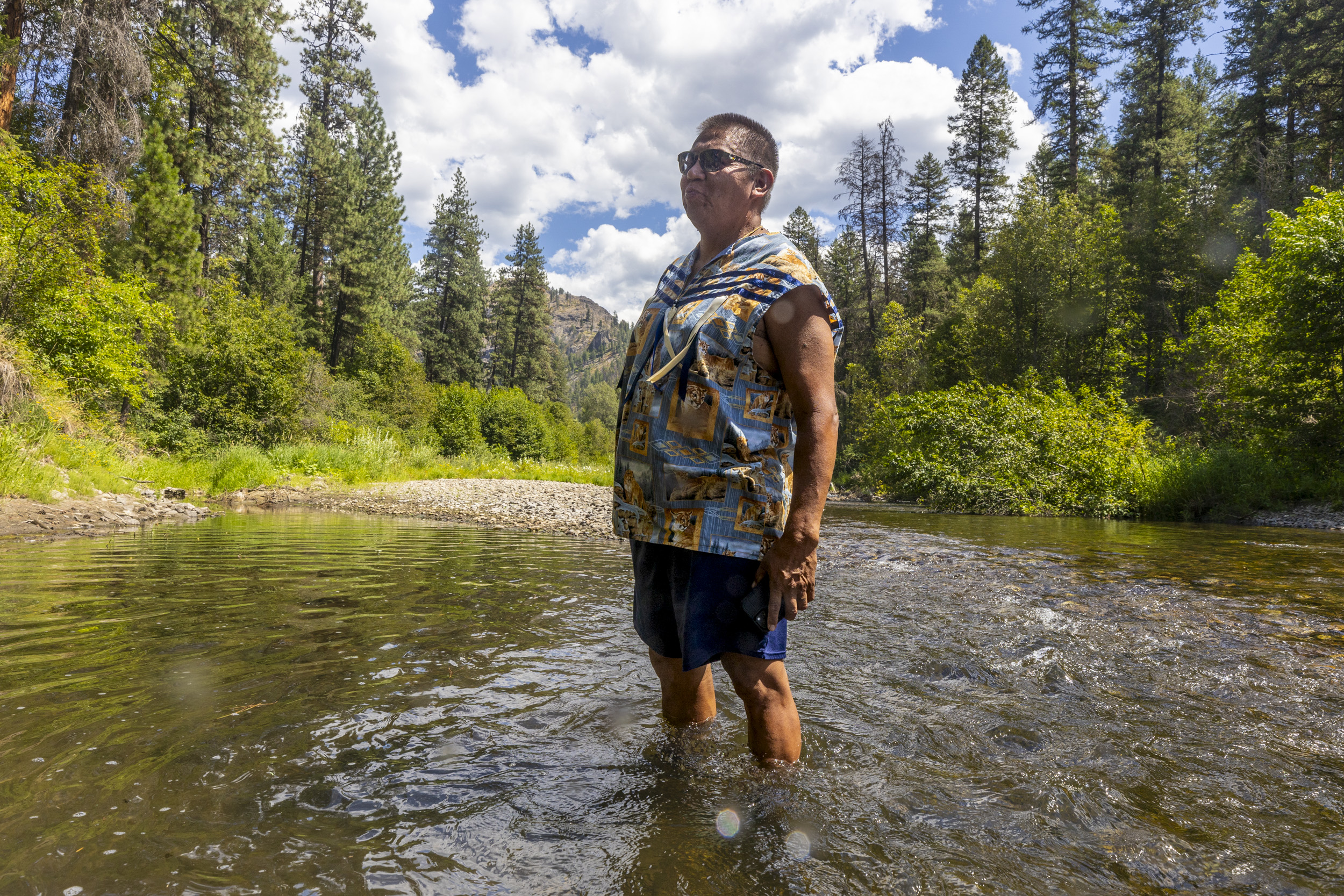 Darnell Sam, Salmon Chief for the Wenatchi, looks on as tribal members release Chinook salmon into the Sanpoil River.