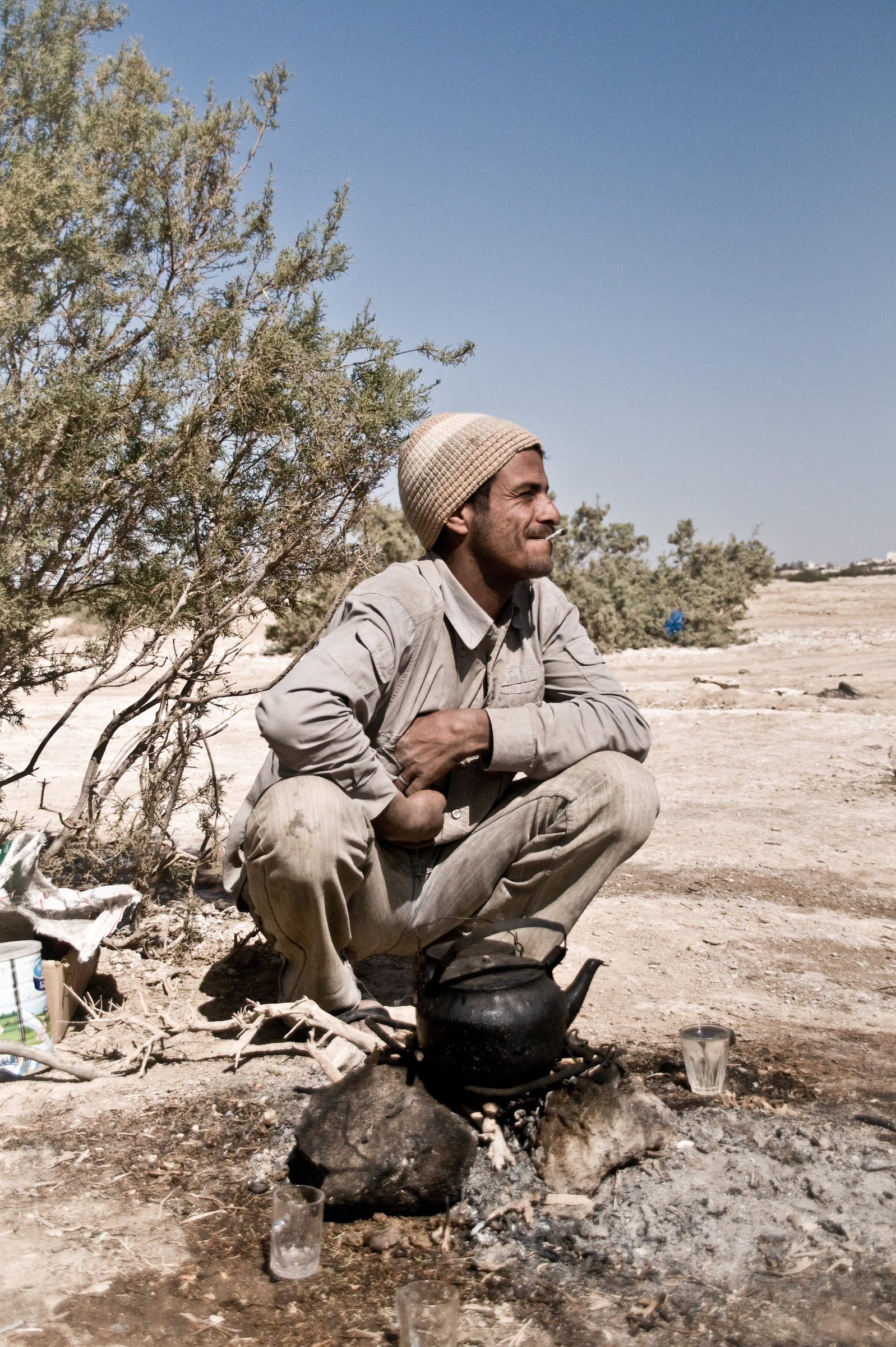 A Bedouin man prepares tea as he waits to be hired for a day’s work of herding and other tasks in the Azraq Oasis. Photograph by John Zada