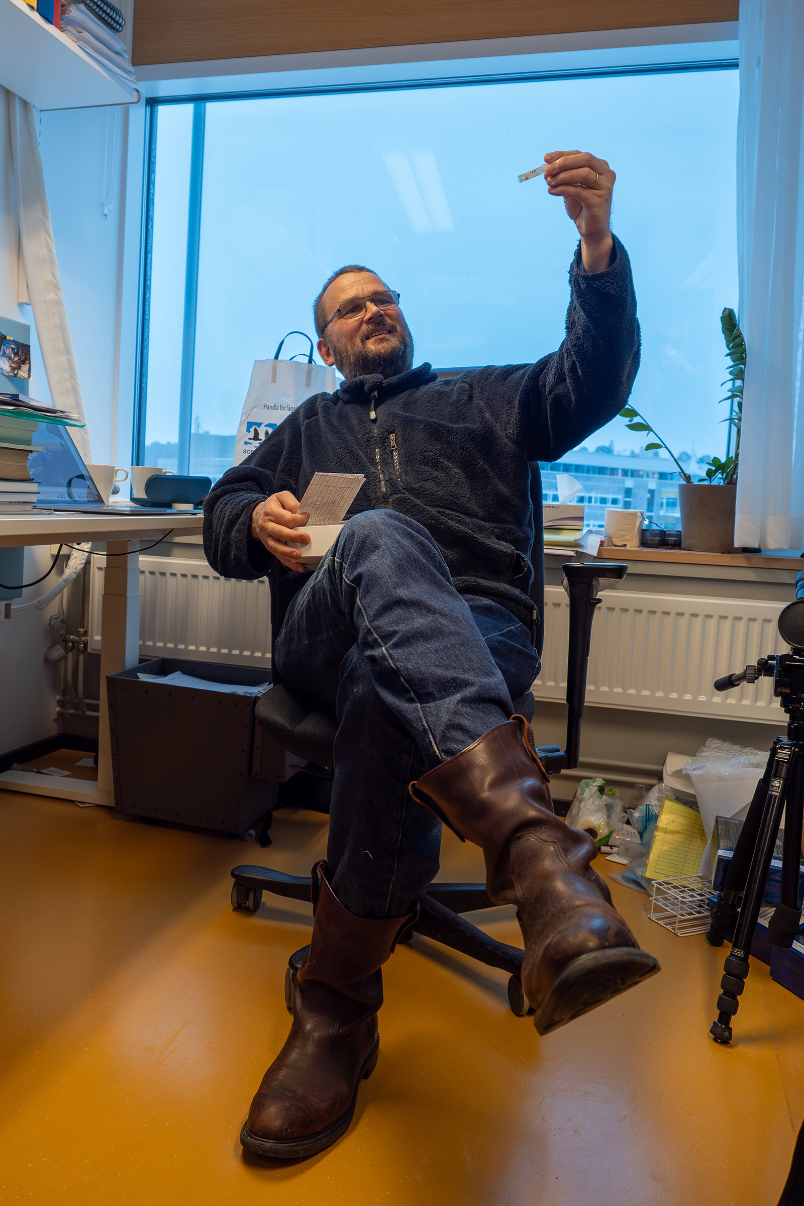 Biologist Carl-Gustaf Thulin sits in his office with a heath hare tissue sample