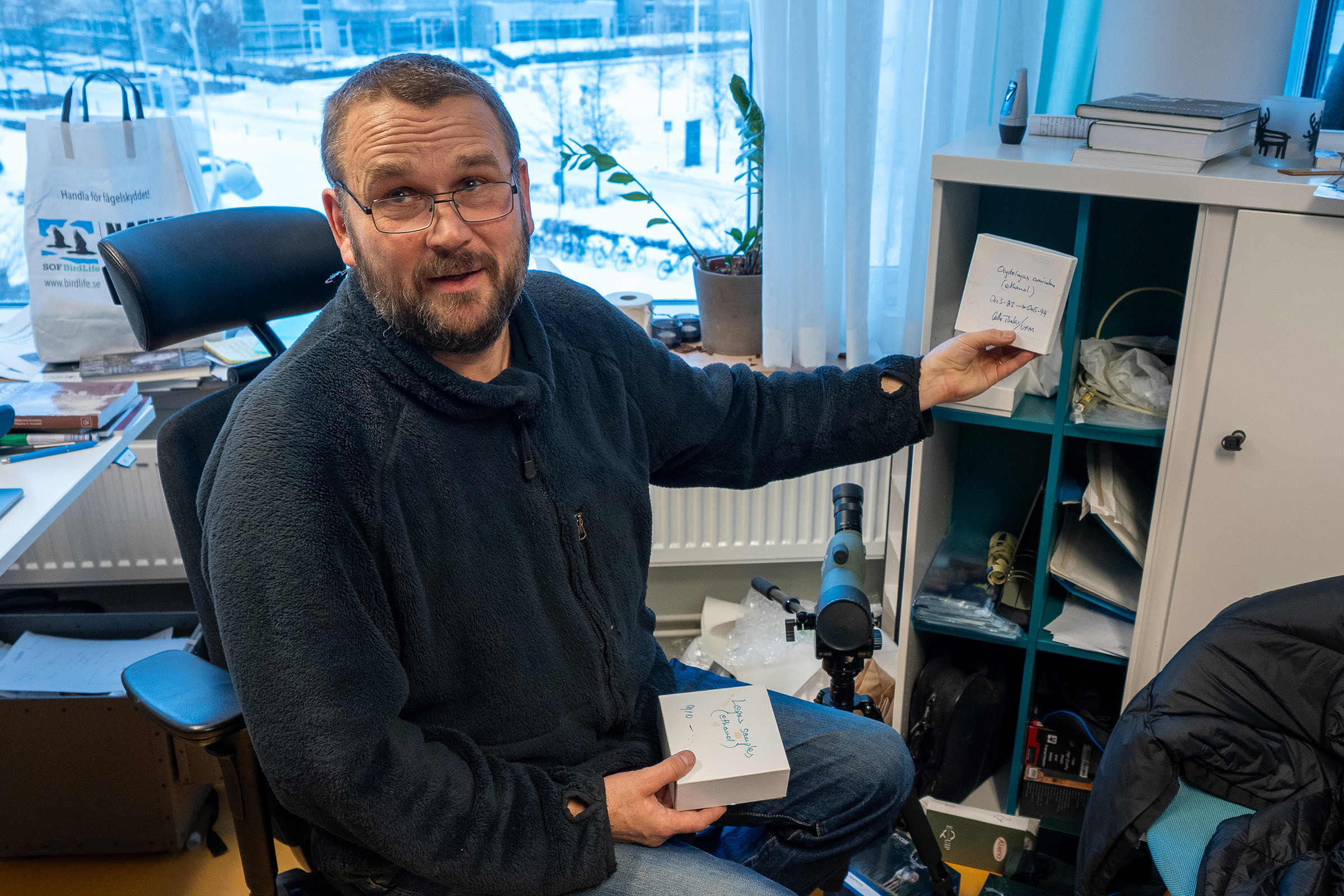 Carl-Gustaf Thulin shows boxes containing tissue samples used to determine the genetic differences between heath hares, northern mountain hares, and European brown hares