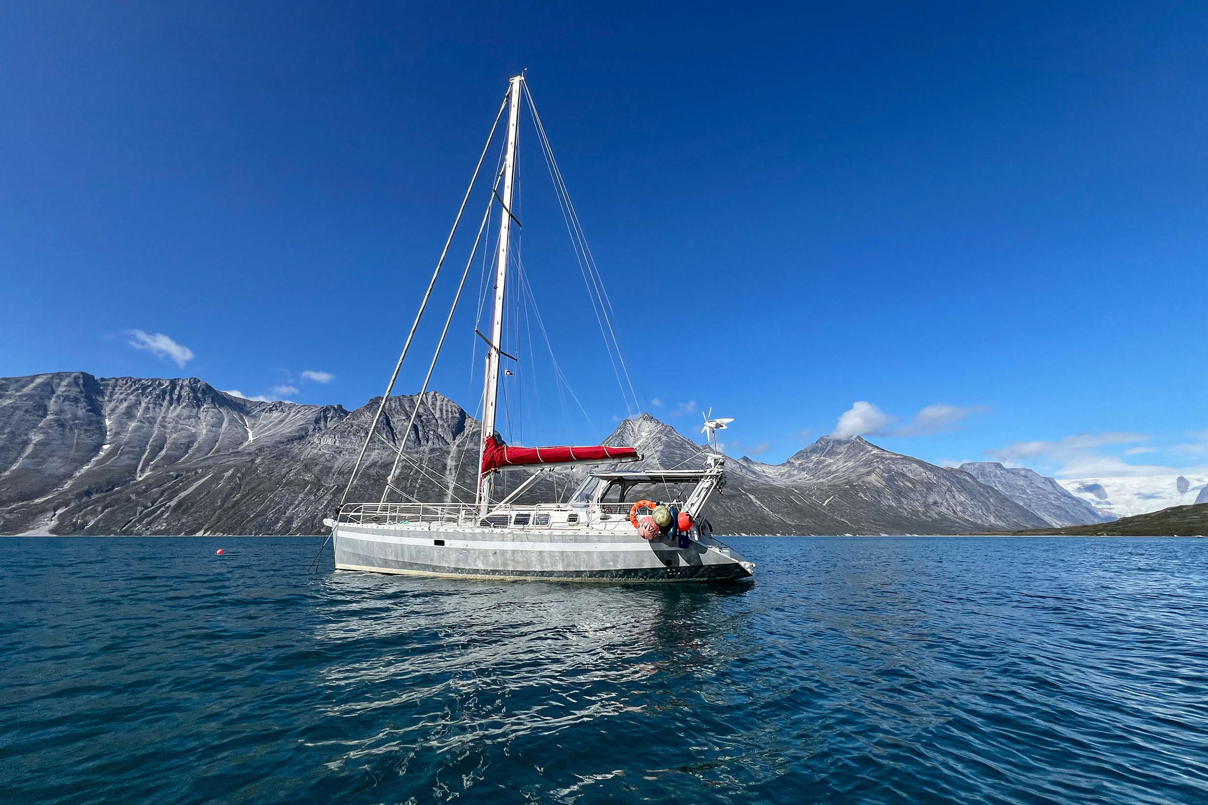 The author and her family spent a year living aboard S/V Turnstone, a high-latitude aluminum sailboat, pictured in Tasermiut Fjord, Greenland. Photo by Caroline Van Hemert