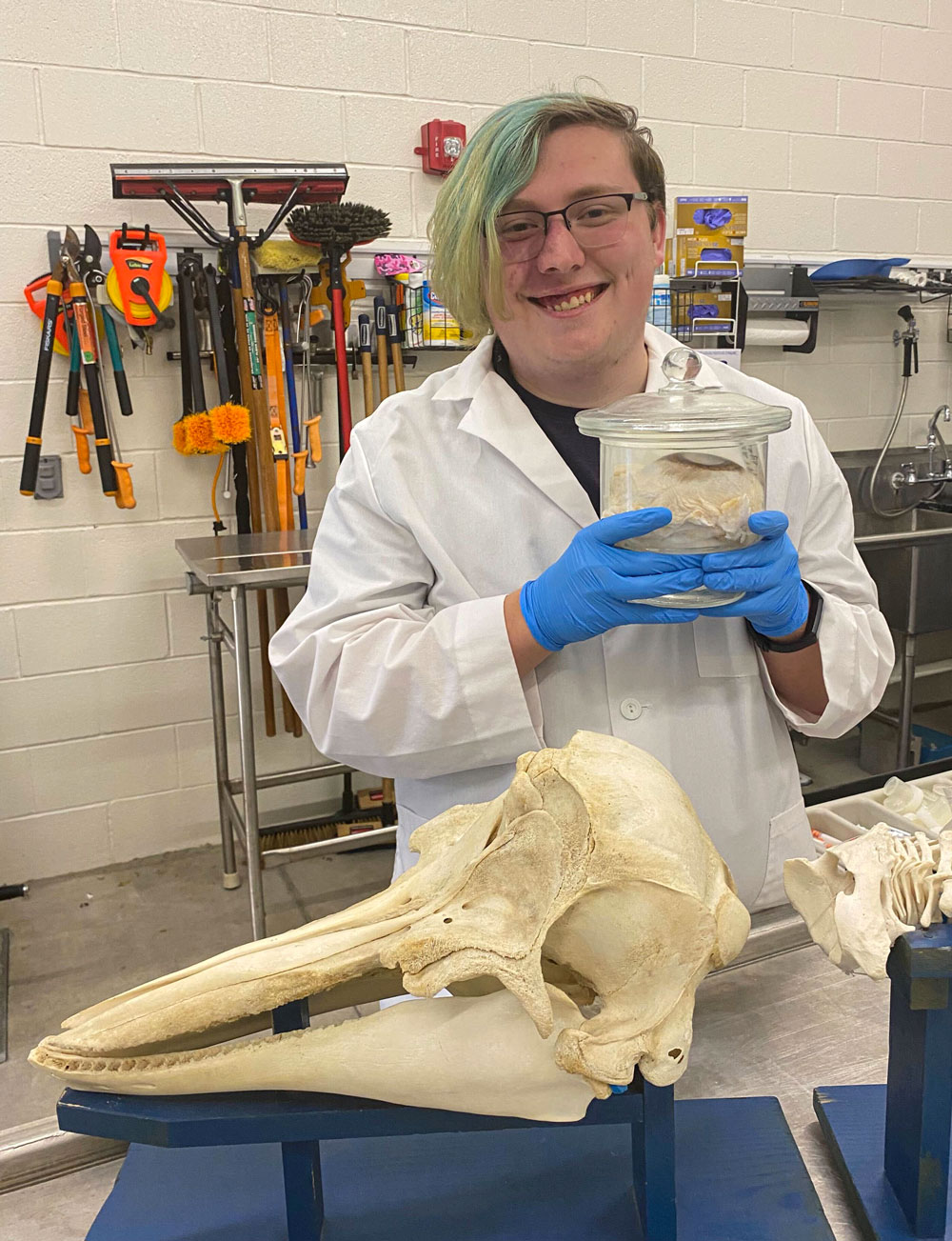 Jacob Bolin holding a humpback whale eyeball in a jar