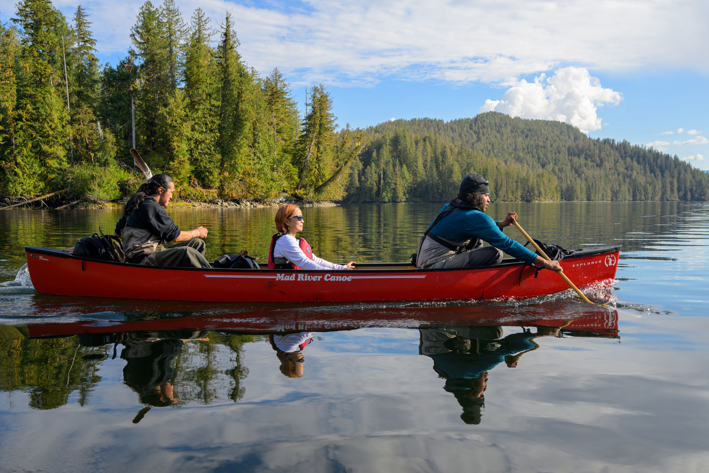 people paddle in a canoe
