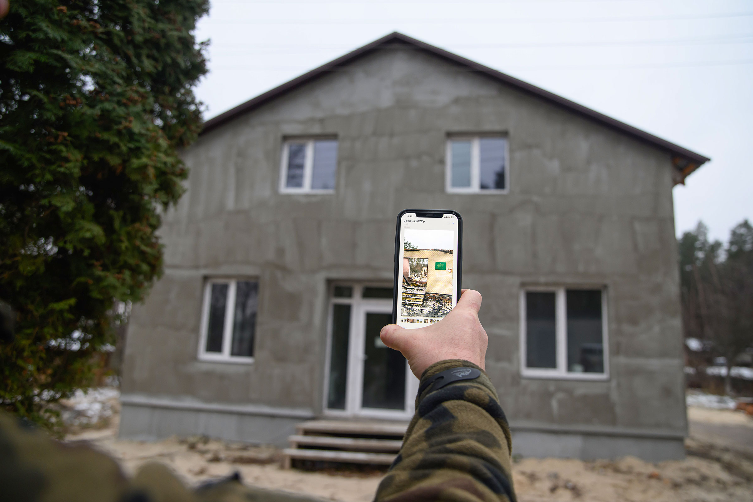 Kohut holds up his phone to show what this newly rebuilt park structure looked like after the events of March 2022.